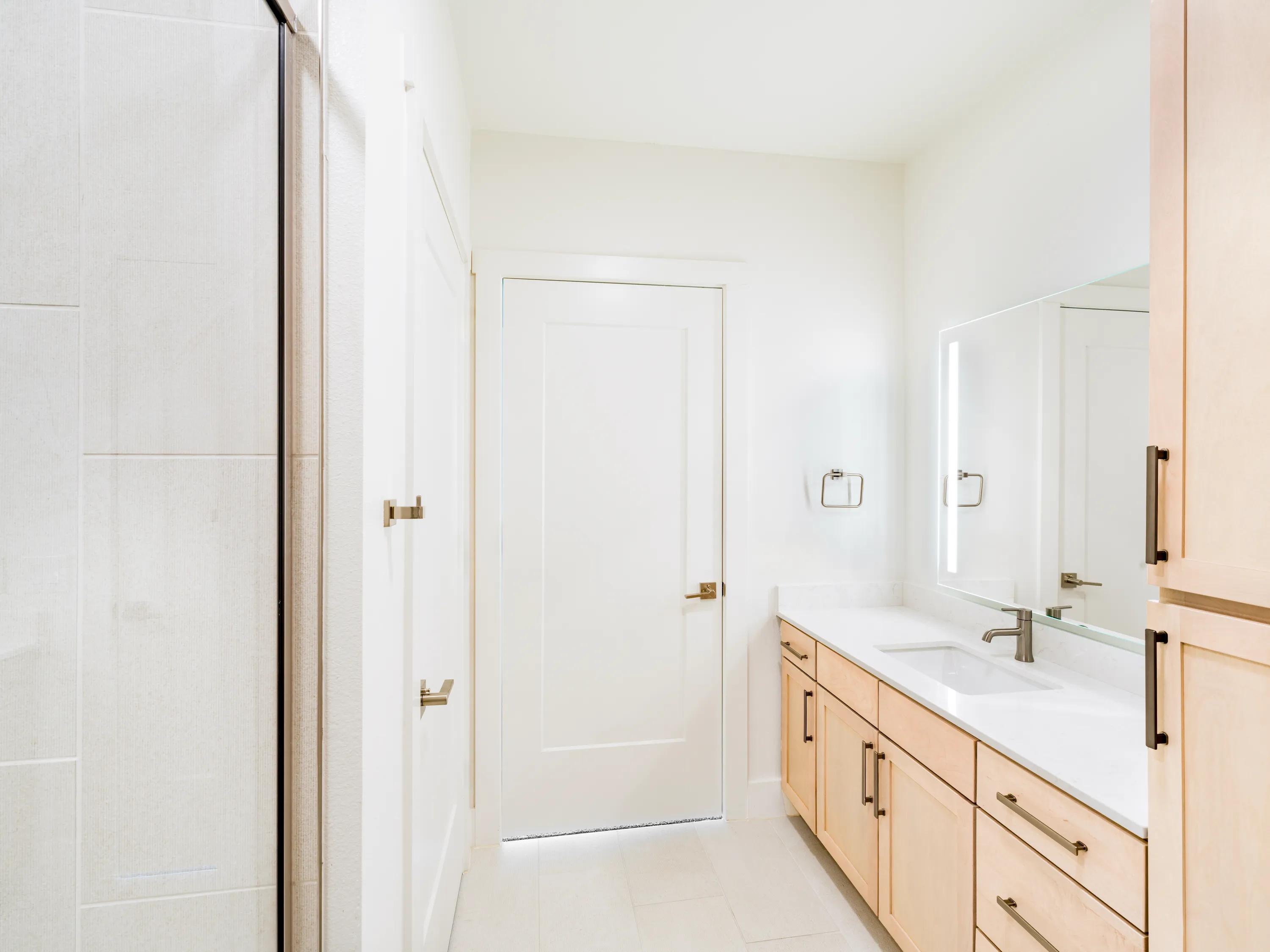 Primary bathroom with a double vanity modera trailhead apartment homes for rent in dallas texas