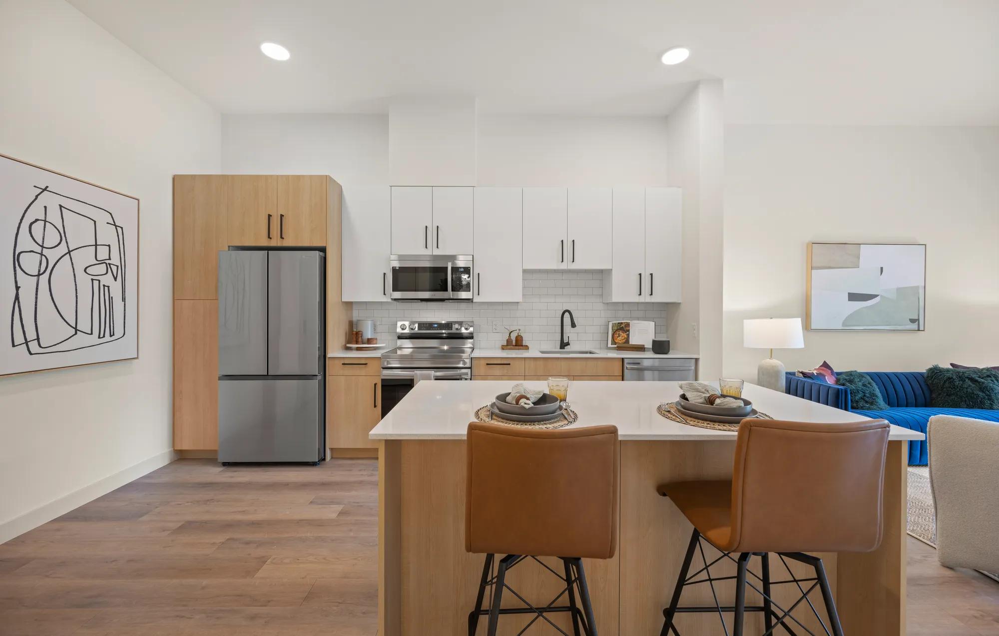 modern kitchen with quartz white countertops and two toned cabinetry at modera newton apartment homes for rent in ma