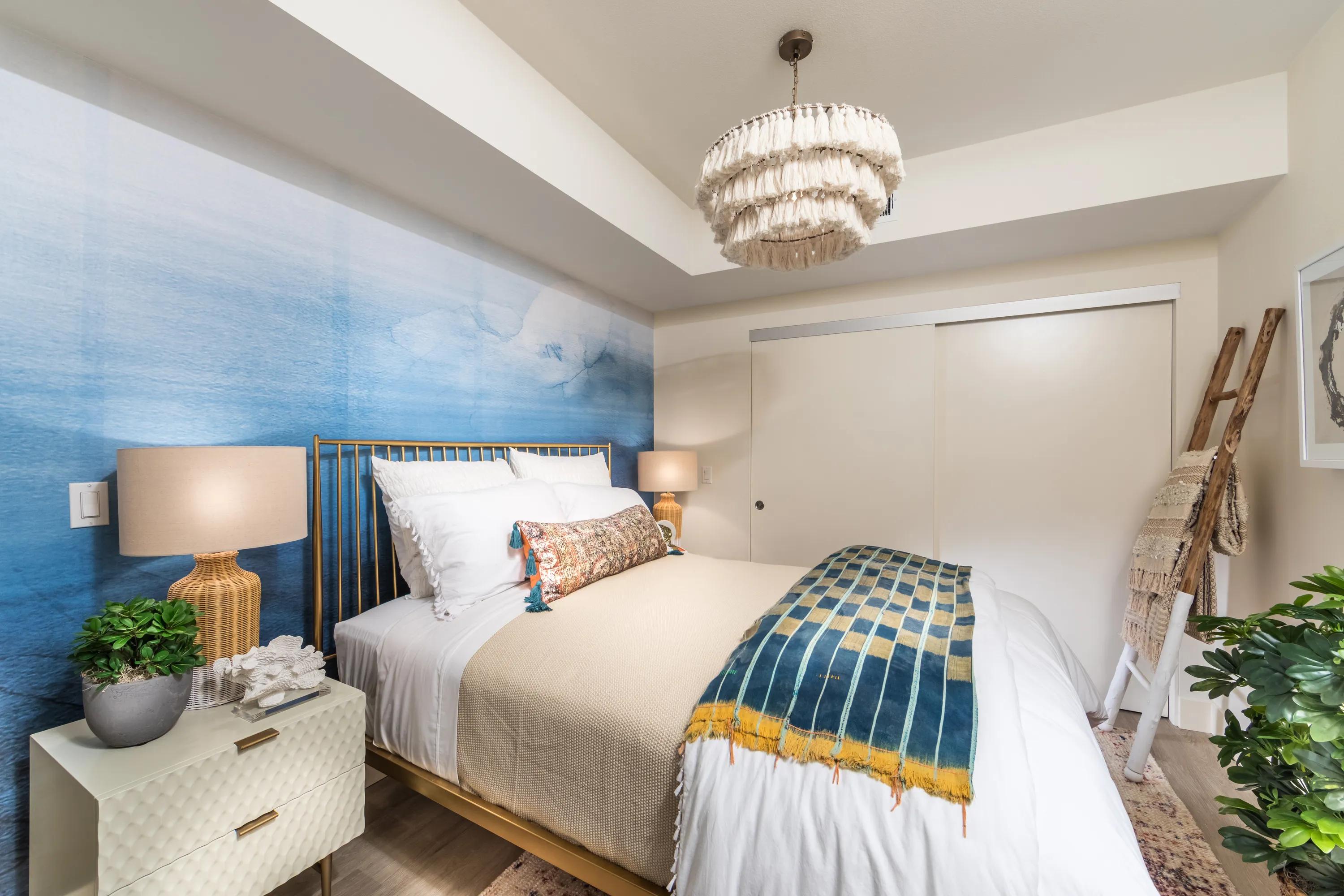 large bedroom with modern lighting and accent wall 580 anton apartments for rent in costa mesa ca