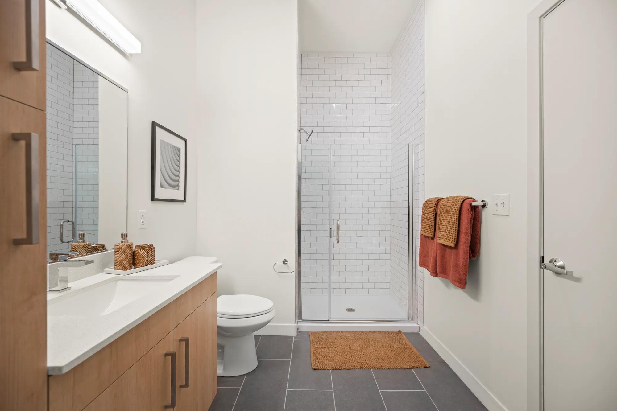 bathroom with subway tile in shower at modera newton apartment homes for rent in ma