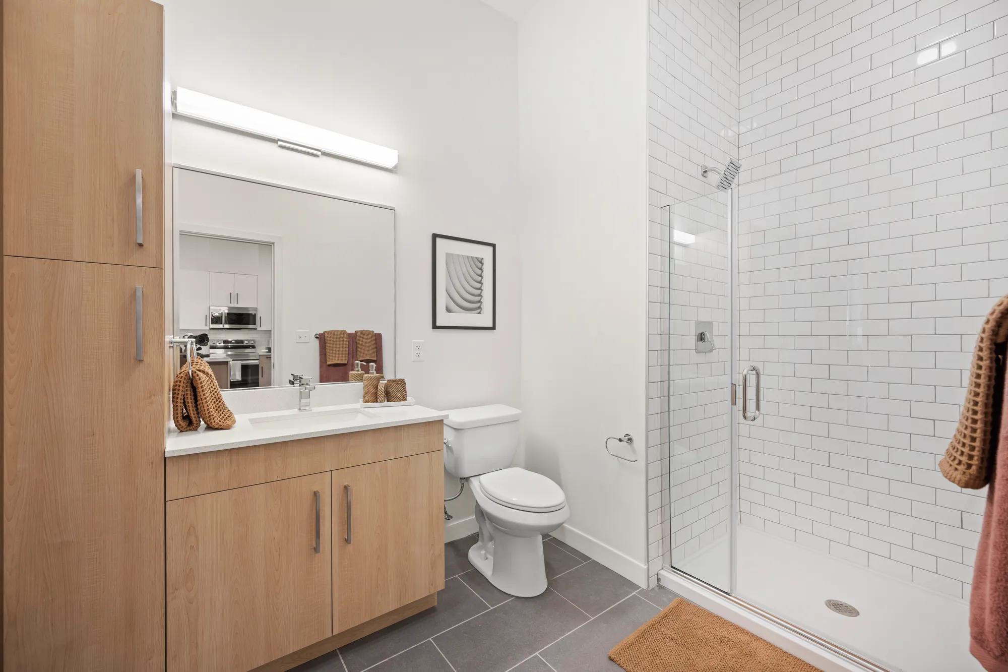bathroom with built in cabintery and quartz countertops at modera newton apartment homes for rent in ma