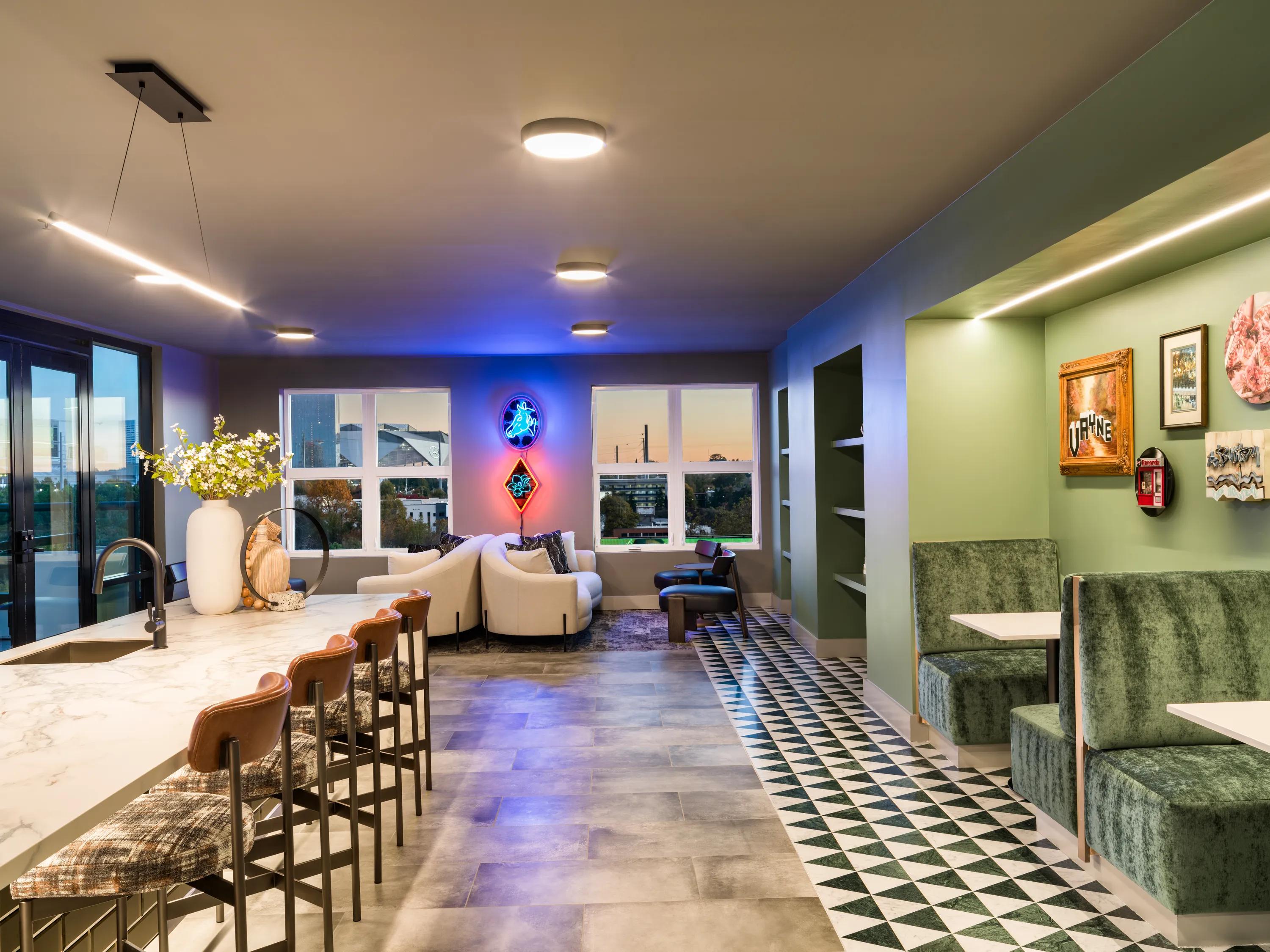 lobby with seating area and neon signage modera westside trail apartment homes for rent in atlanta ga