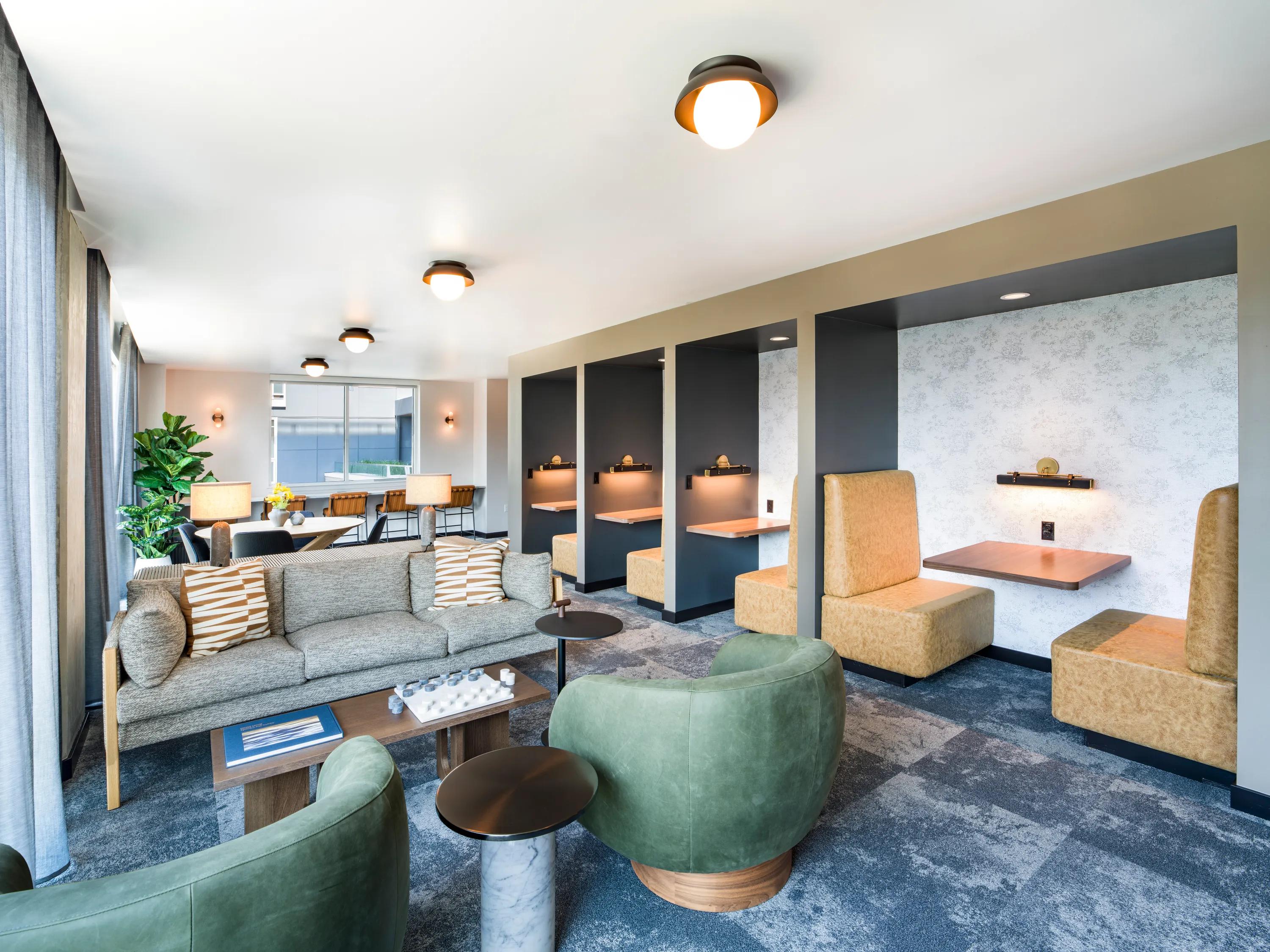 Coworking space with private work stations and covered coworking terrace with lounge seating
