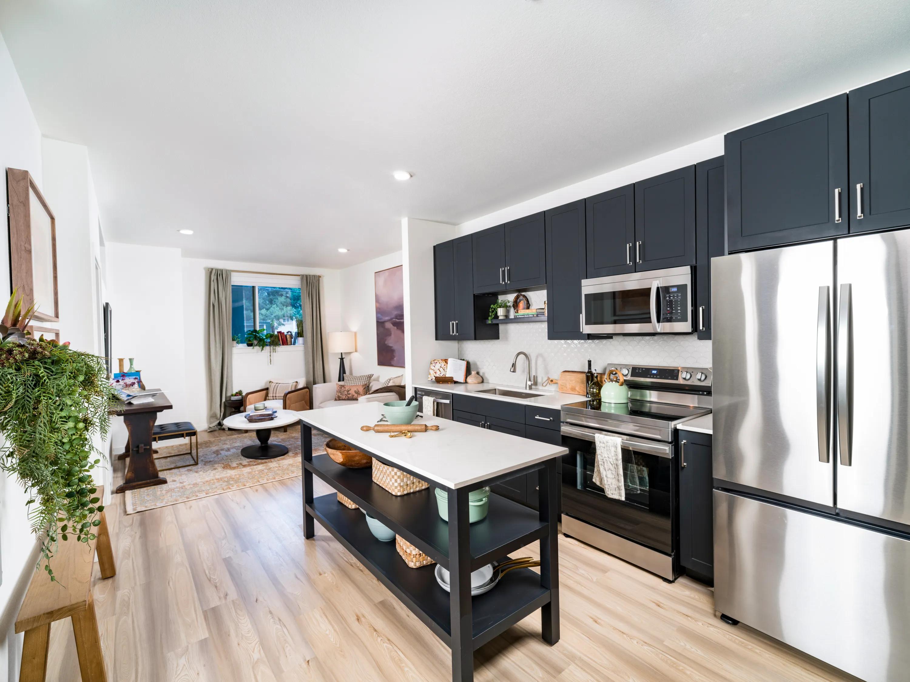 kitchen with dark cabintery and quartz countertops at modera university park apartment homes for rent in denver co