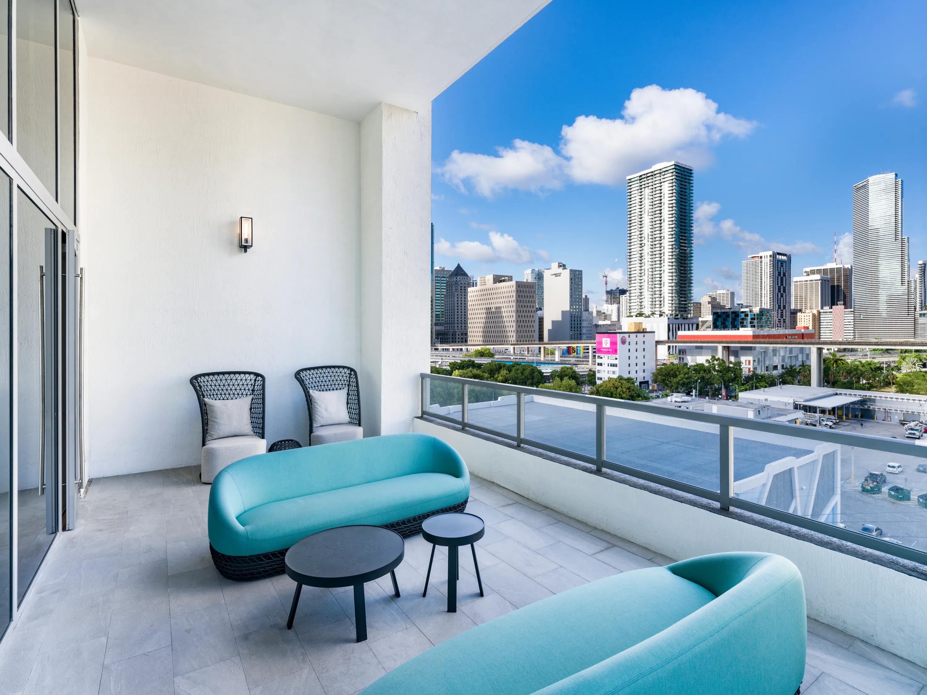 private balcony bedroom with large windows looking towards city modera riverside apartment homes for rent in miami fl