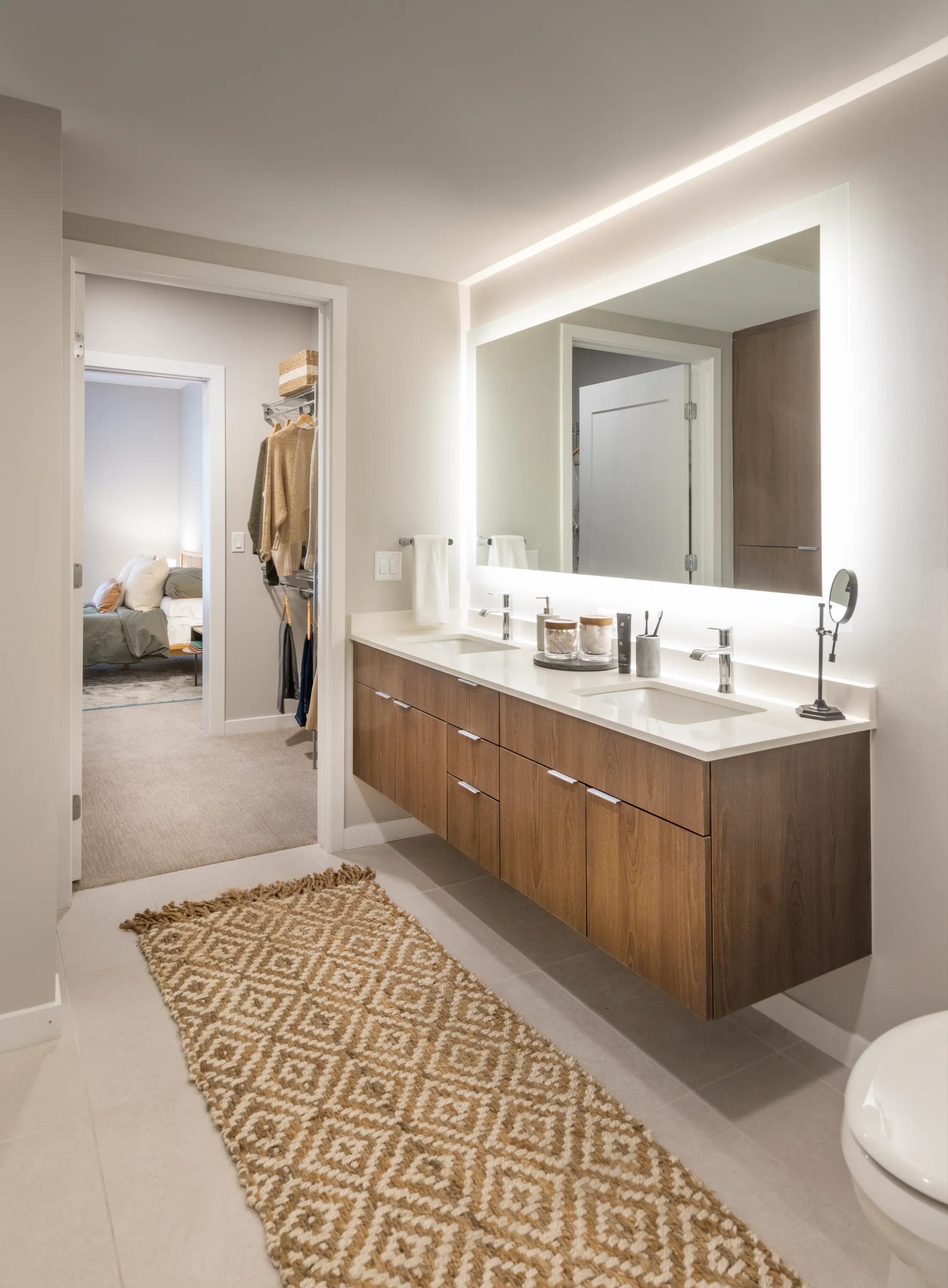 Ultra modern bathroom with floating vanities and pass-through closet modera lohi apartments in denver co
