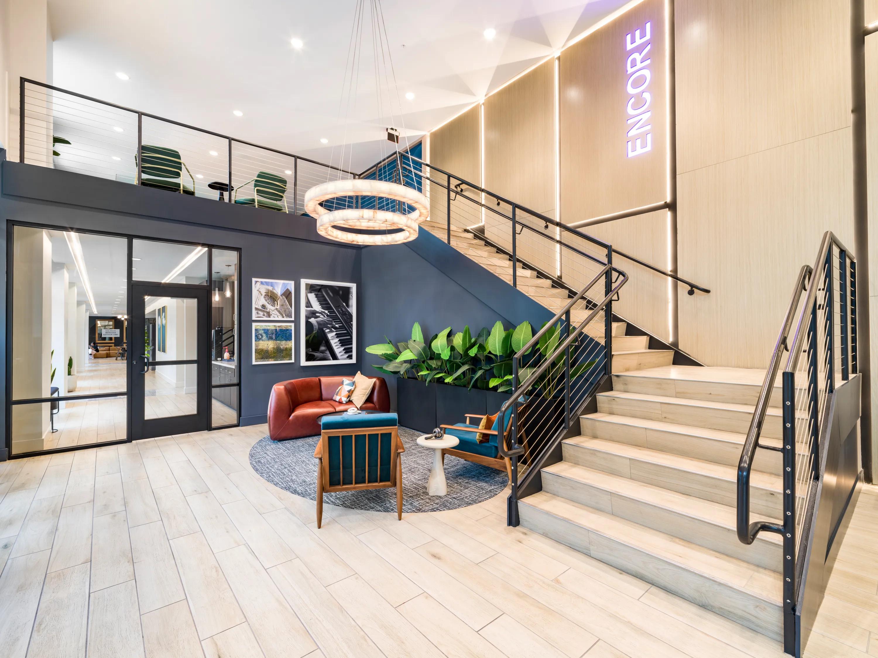 lobby with large staircase and adjacent seating modera encore apartment homes for rent in tampa fl