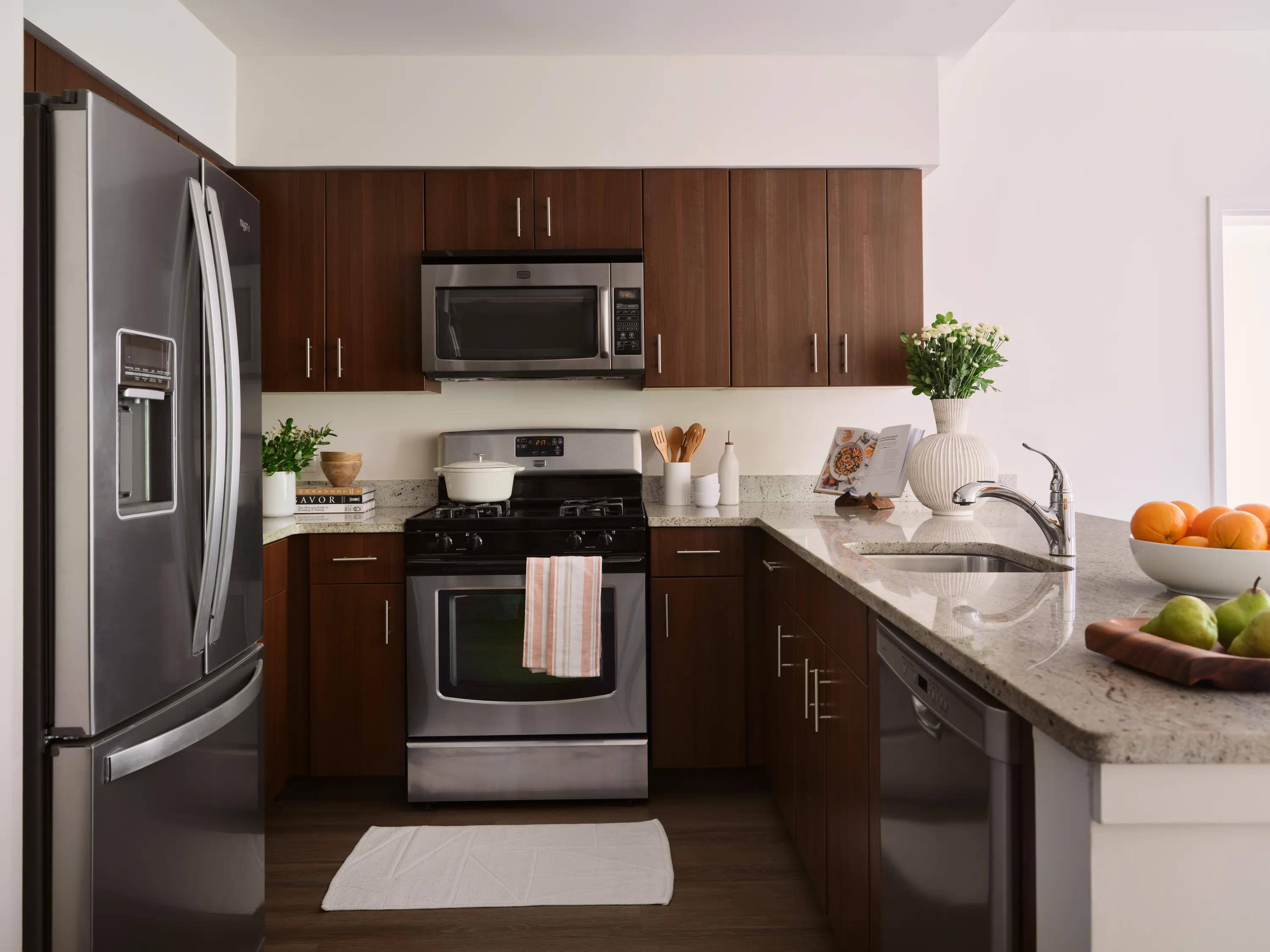 kitchen with dark cabinetry and stainless steel appliances metropolitan at 40 park apartment homes for rent in morristown nj