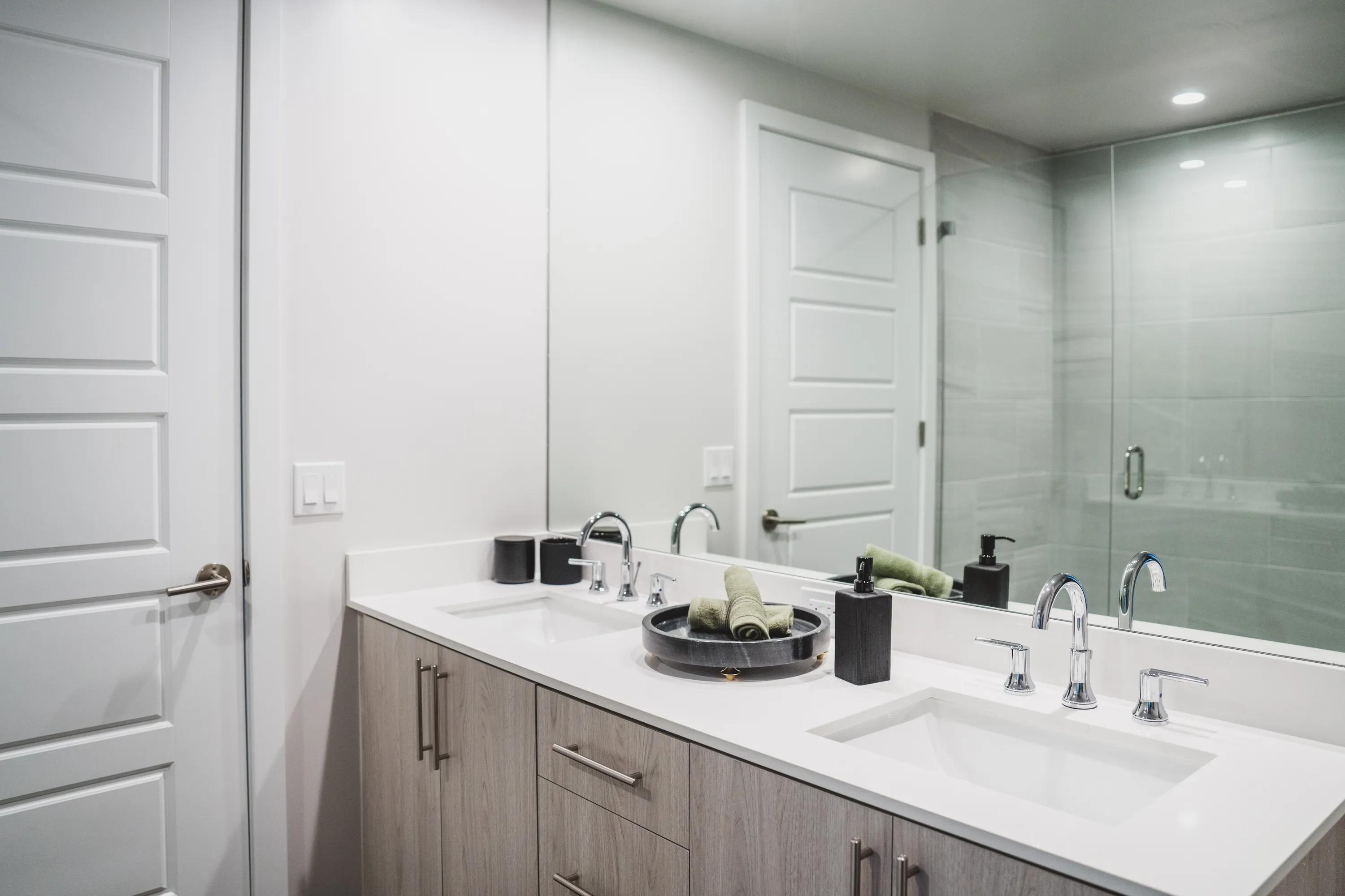 high-end bathroom with a double-vanity at modera coral springs apartment homes for rent in florida