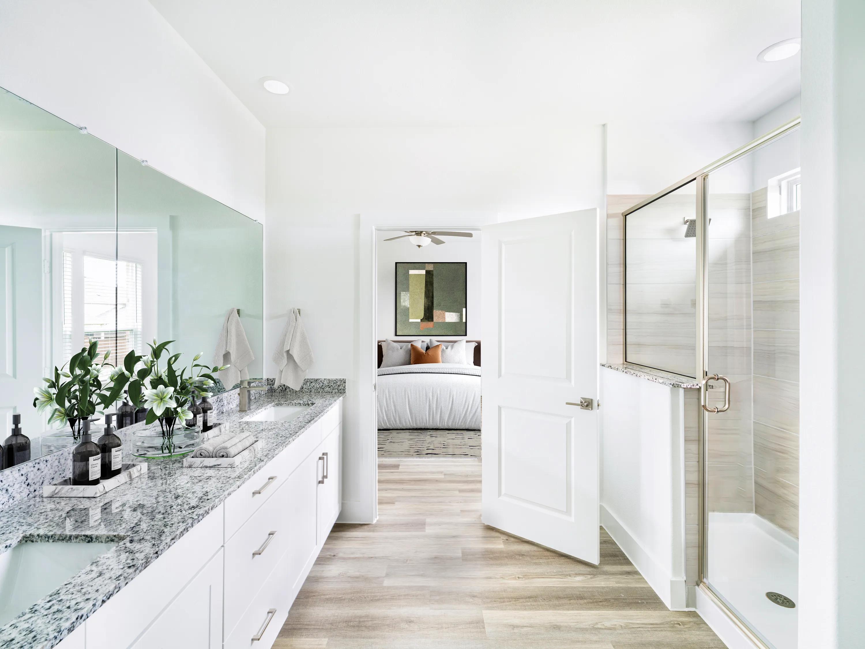 bathroom with large mirror and double vanity at amavi celina single family homes for rent in texas