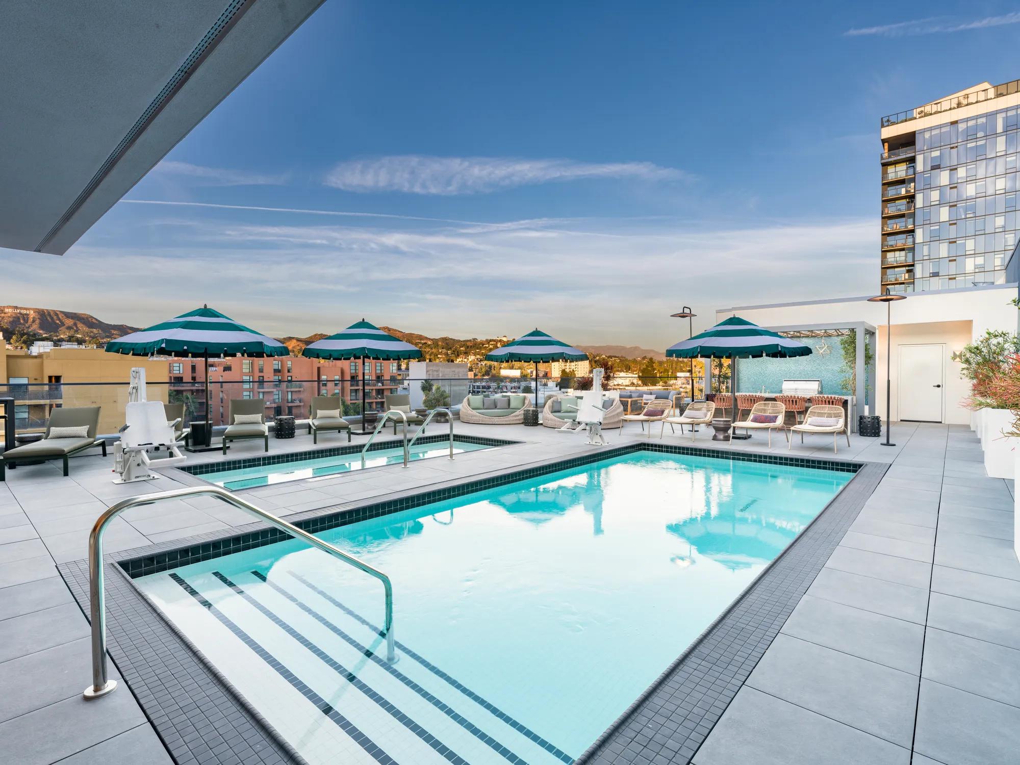 rooftop pool with daybed and sunshades
