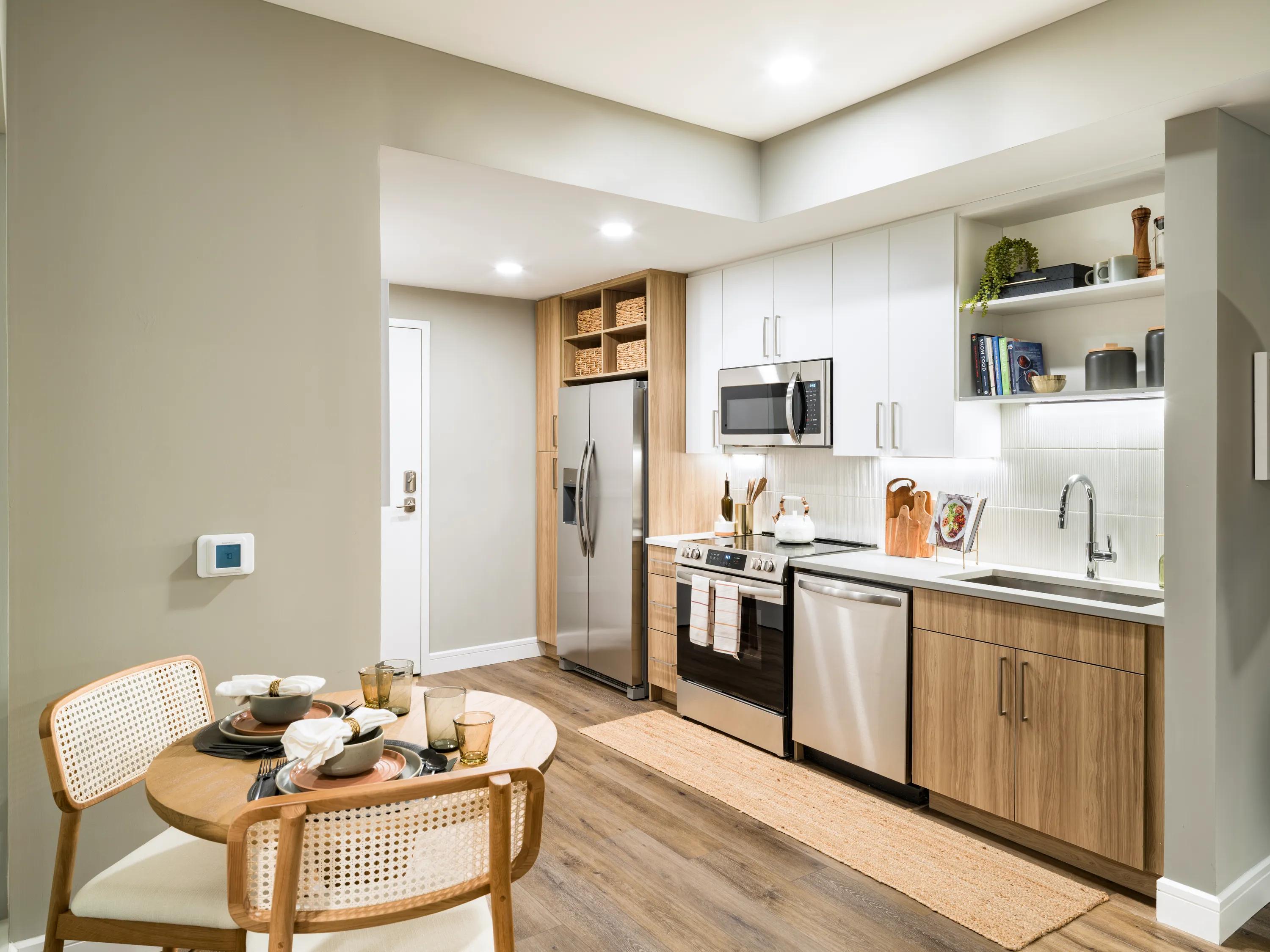 Gourmet kitchens with quartz countertops, 42-inch custom cabinetry with soft close, and under-cabinet lighting