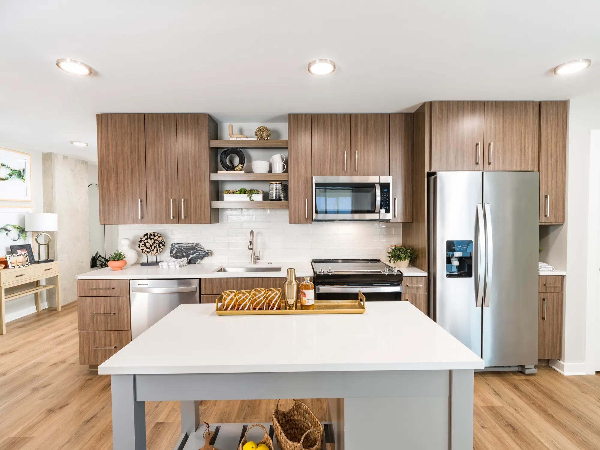 kitchen island in kitchen with stainless steel appliances and dark brown cabinetry modera loso apartment homes for rent in charlotte nc