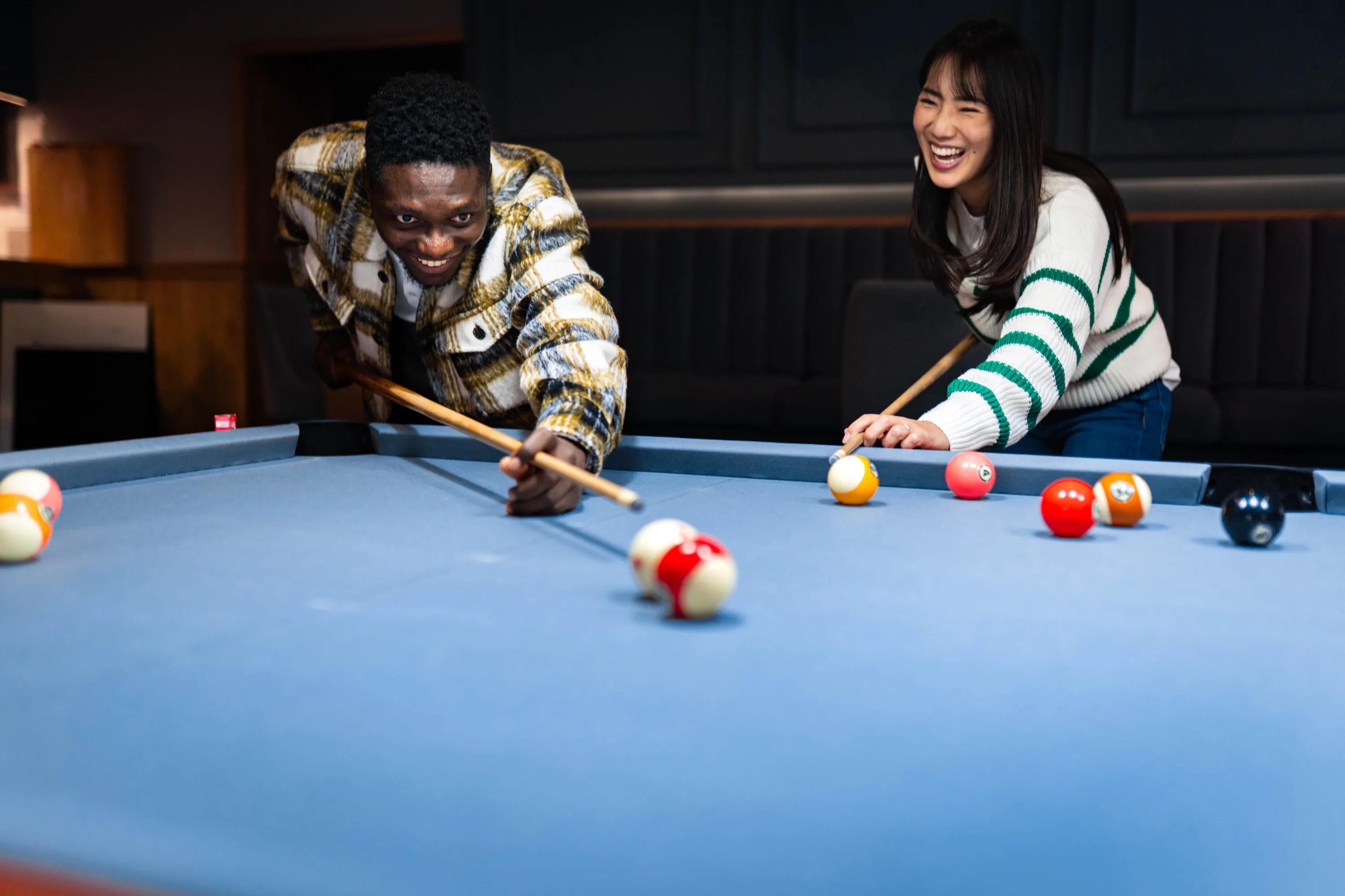 group of friends playing pool modera ridgeline apartments in mckinney tx