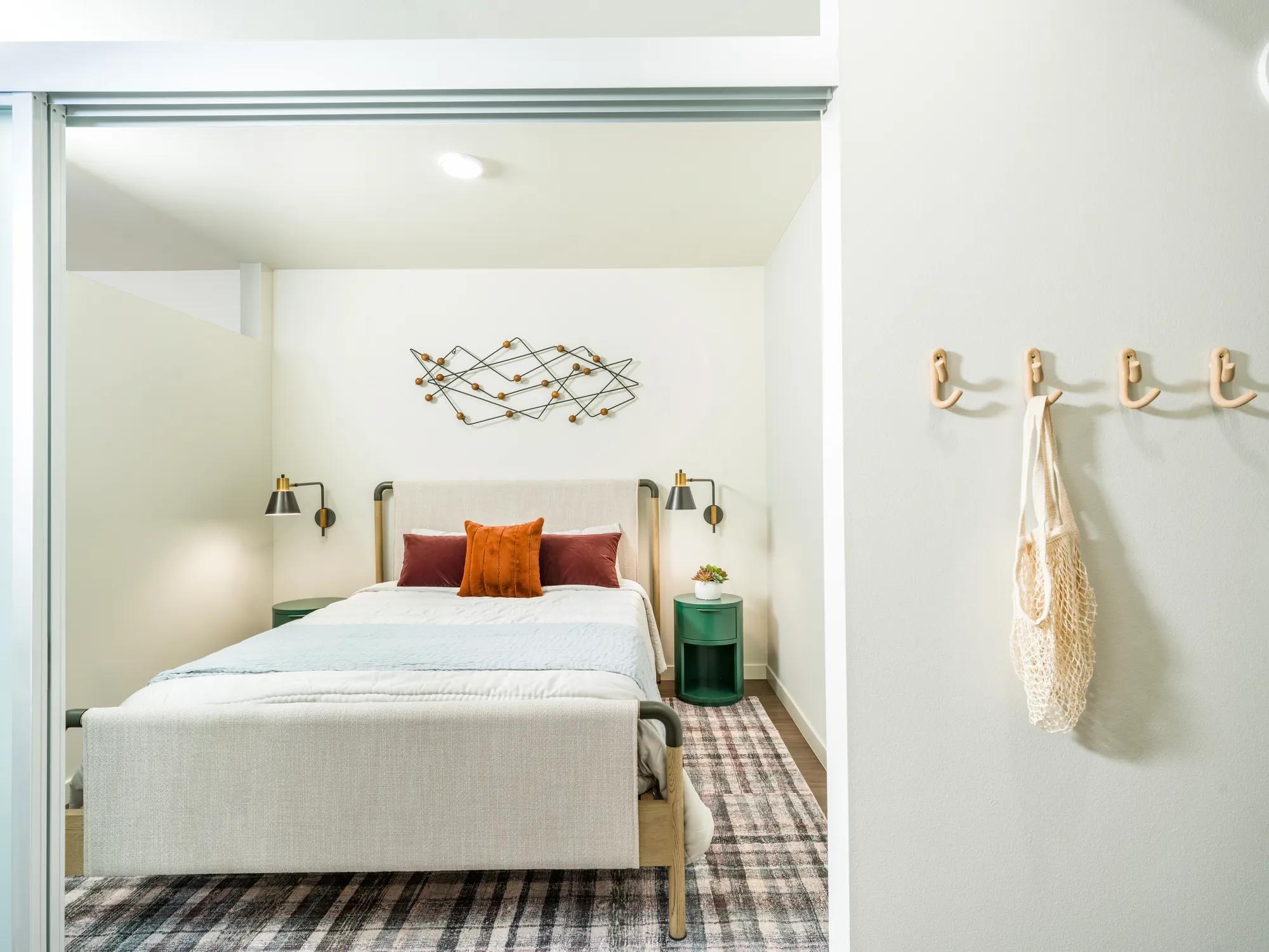 Bedroom with queen bed in studio floor plan