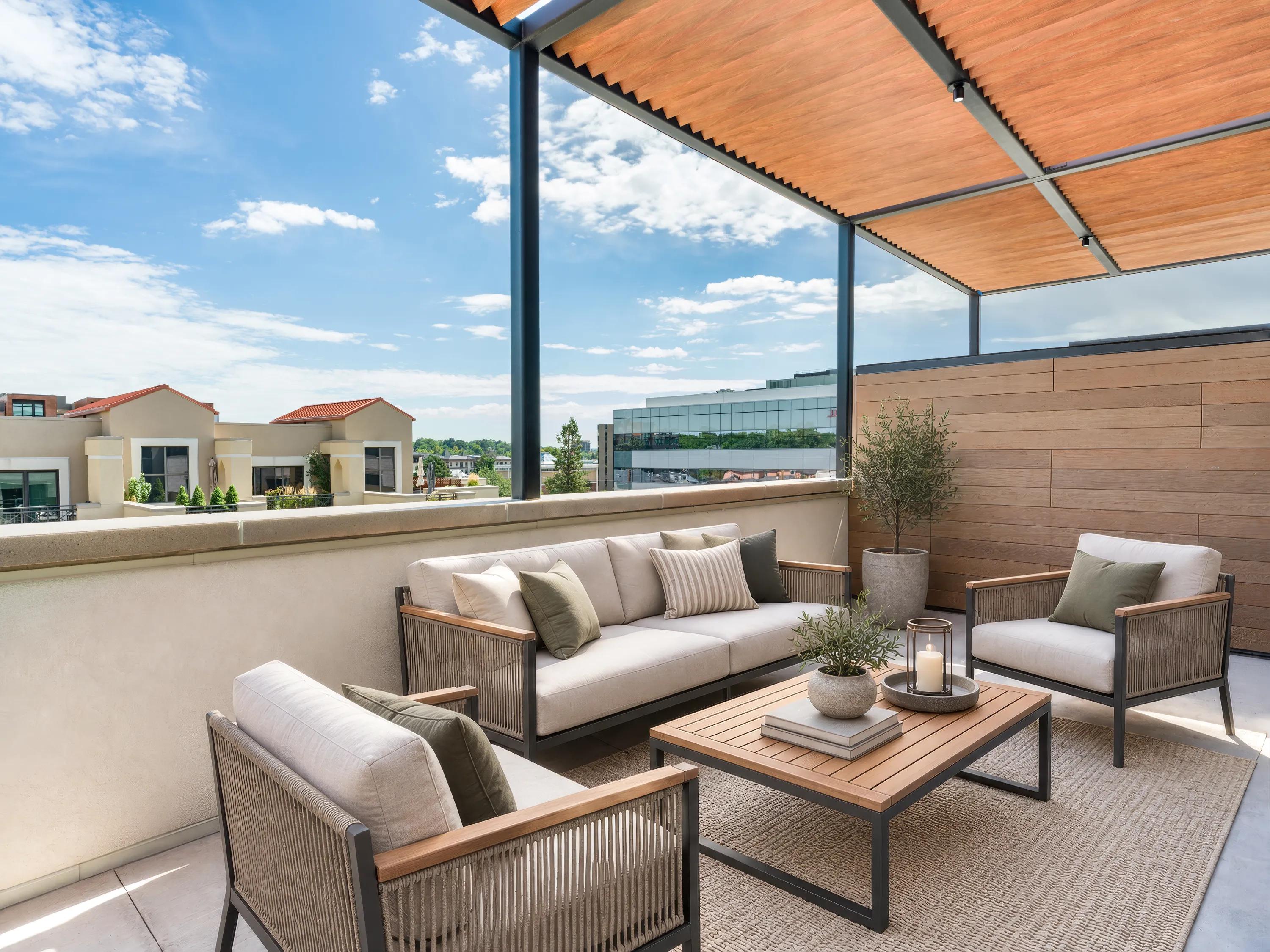 Private rooftop terrace with outdoor lounge seating, a pergola-covered gathering area, and neighborhood views at Modera Second Avenue apartments in Denver, CO.