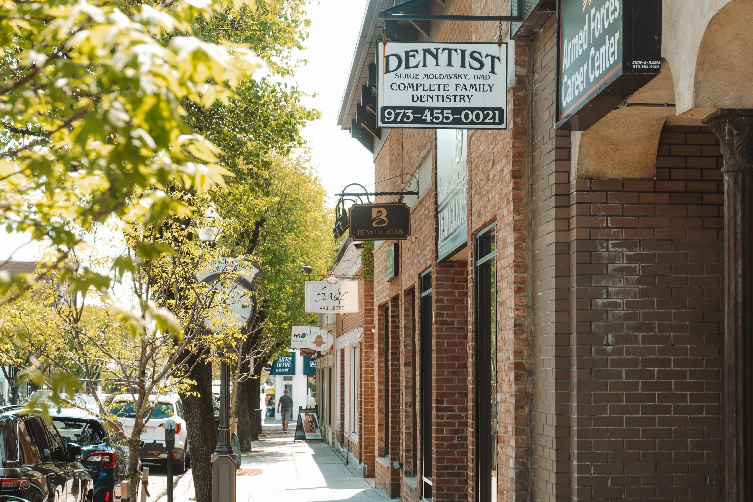signs to various retail spaces along sidewalk metropolitan at 40 park apartment homes for rent in morristown nj