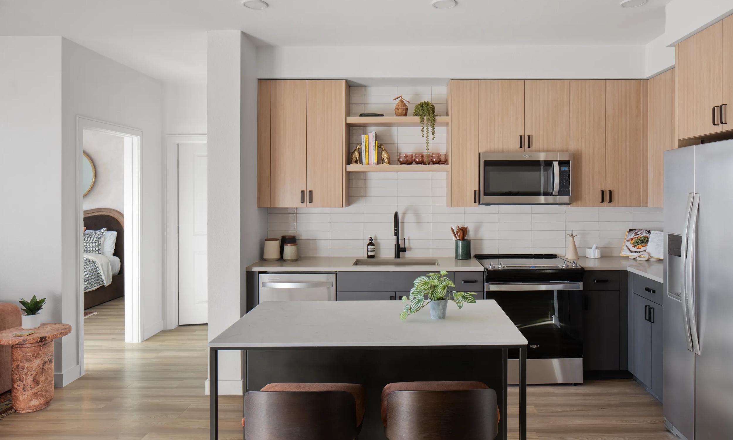 two-toned cabinetry and open shelving in modern kitchen modera rio salado apartment homes for rent in tempe az