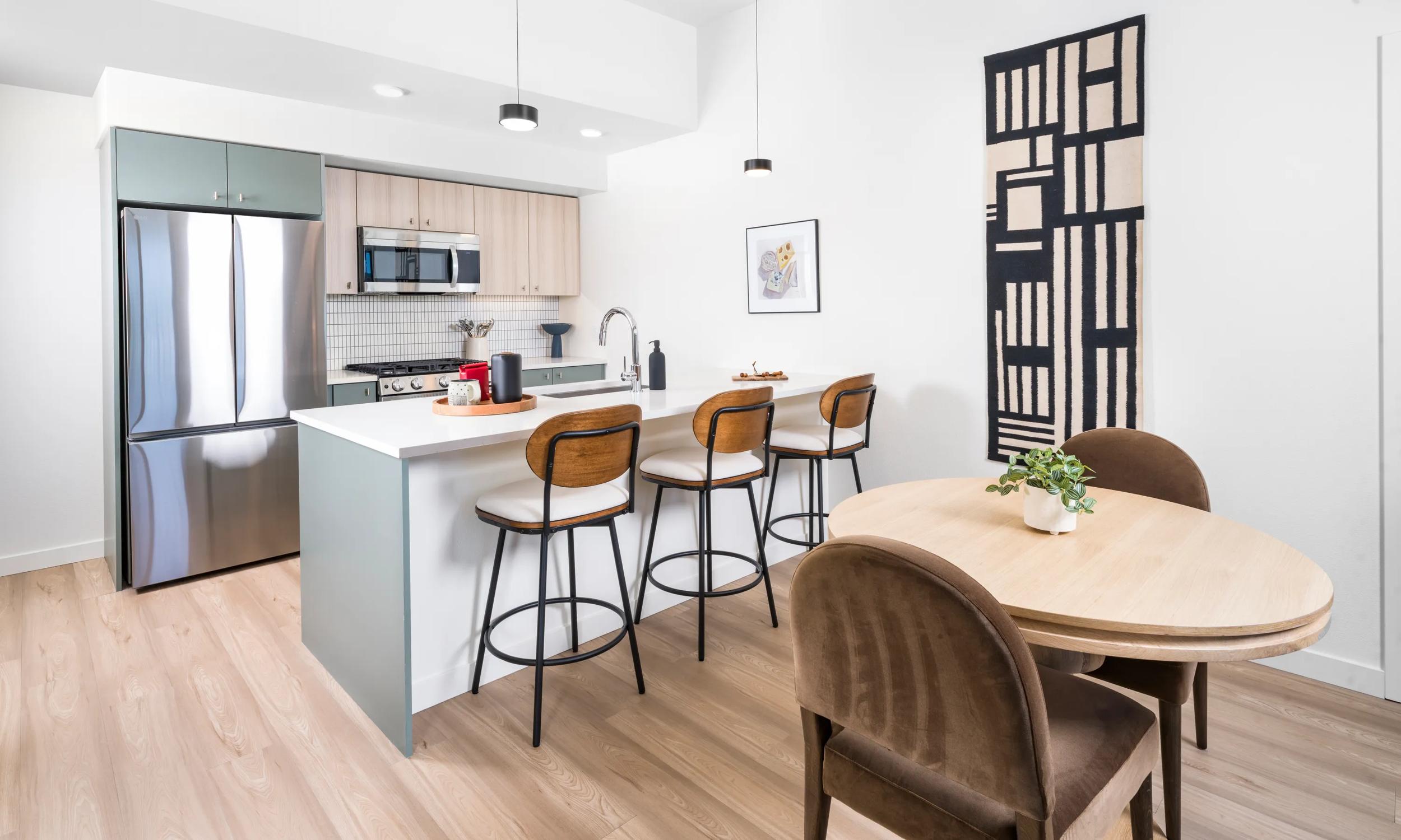 modera beaverton apartments in beaverton or near portland kitchen with green and white custom cabinetry and stainless steel appliances