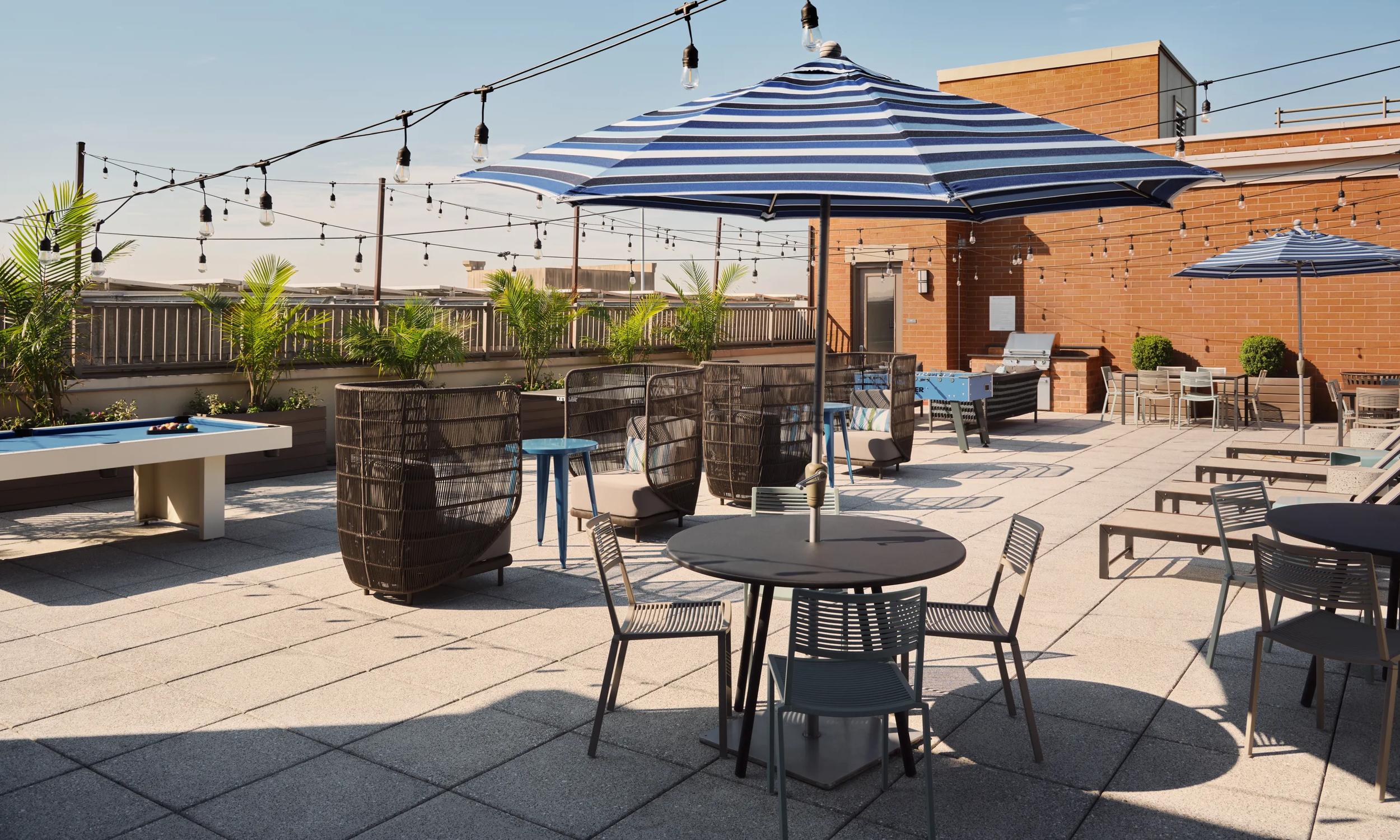 rooftop deck with string lights and lounge seating the metropolitan at 40 park morristown nj apartments for rent