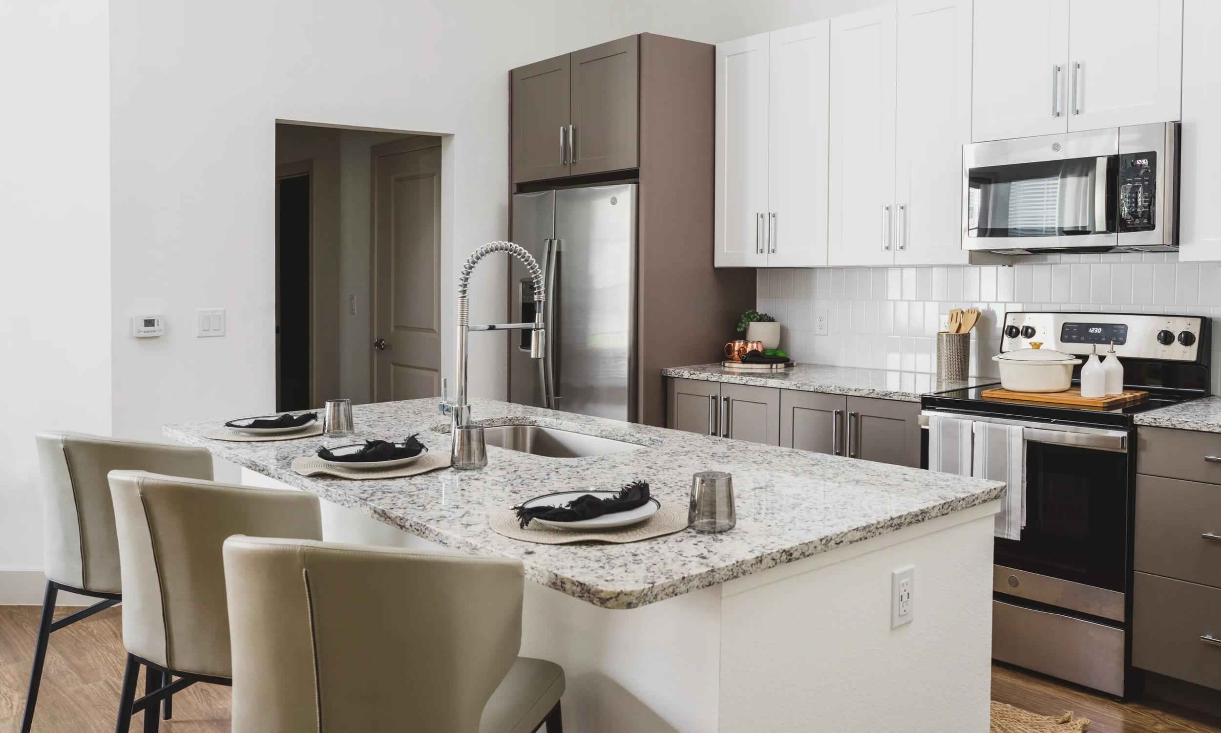 kitchen with two tones cabinetry and stainless steel appliances modera frisco square apartments in frisco tx
