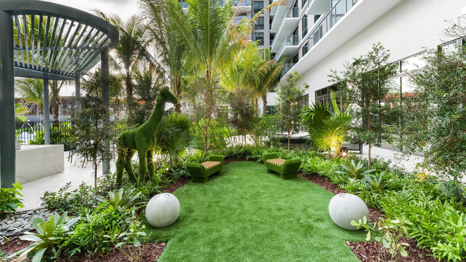 modera aventura apartments outdoor garden with sculptures