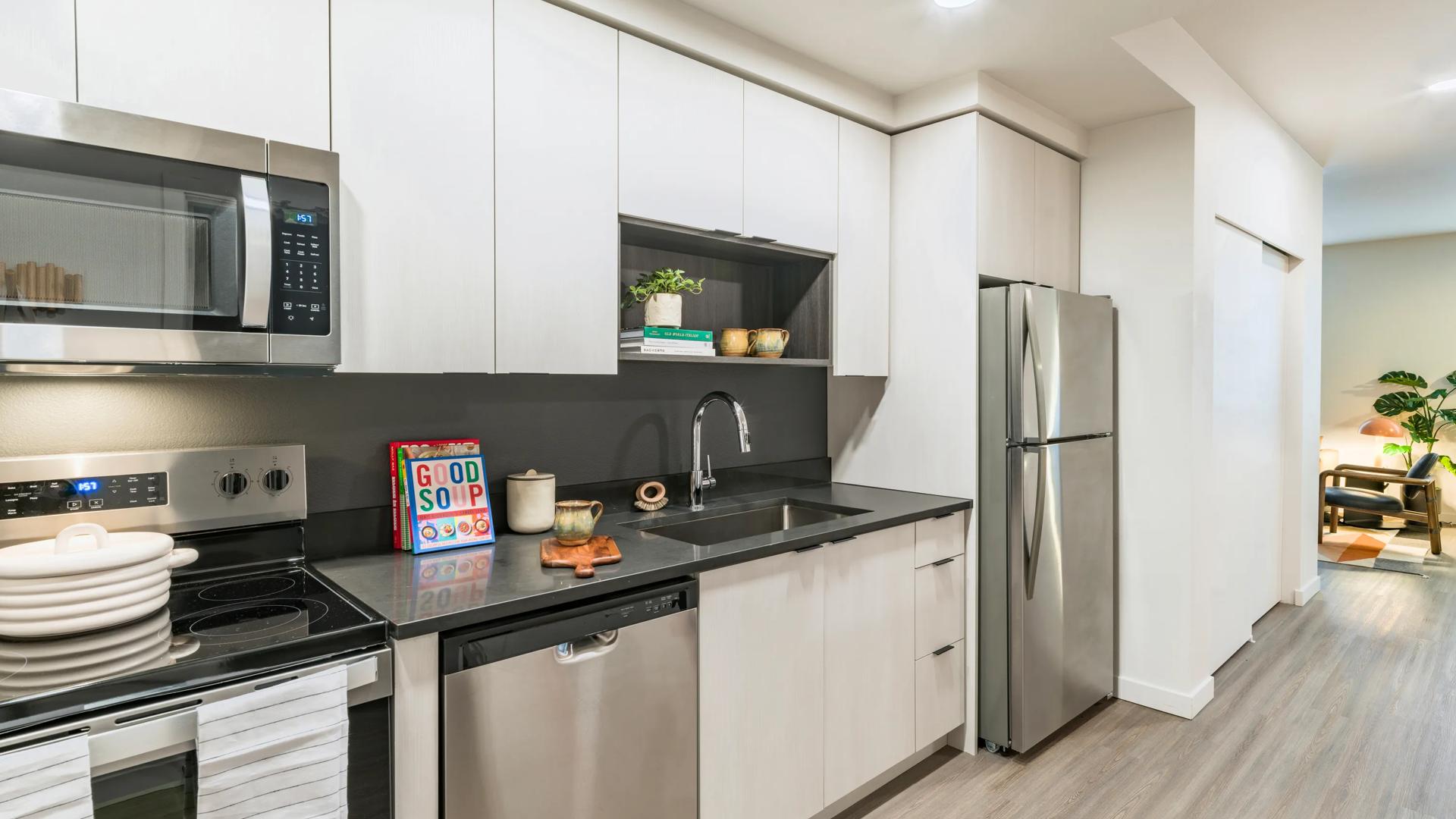 interior white kitchen with stainless steel appliances modera woodstock portland apartments