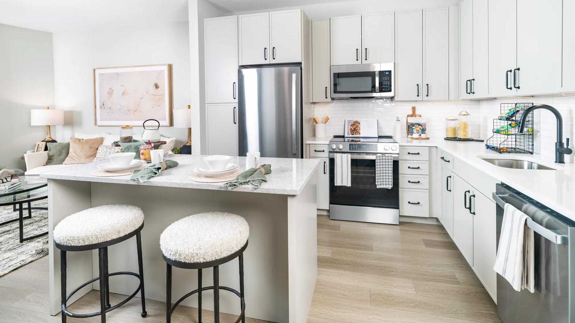 kitchen with stainless steel appliances and island modera falls church apartment homes for rent in va