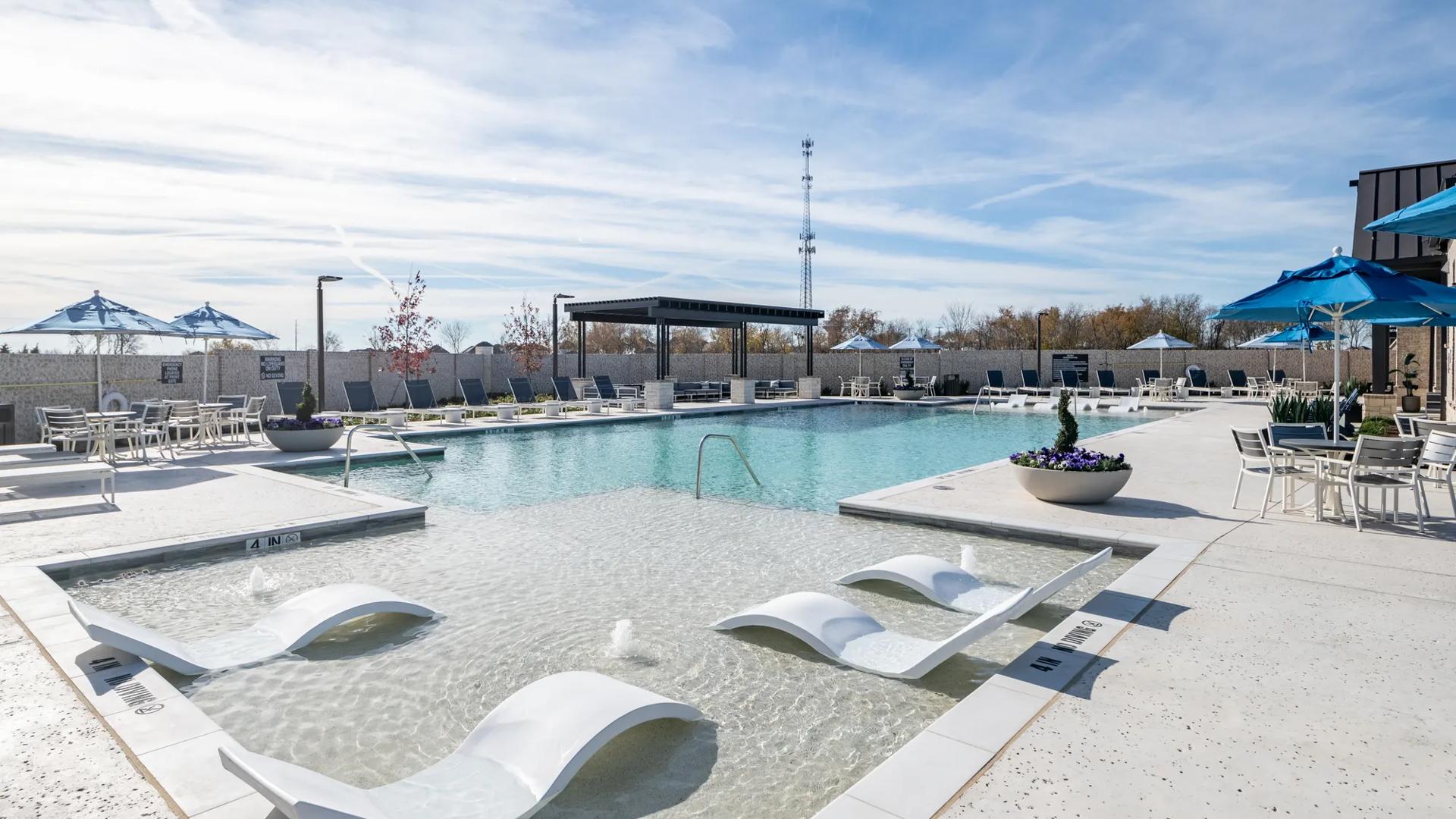pool with sundeck and in-pool seating amavi celina homes for rent