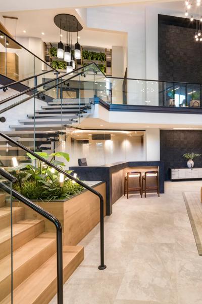 clubhouse with grand staircase looking towards large windows modera falls church apartment homes for rent in va