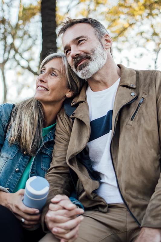 couple sitting outside in cold weather holding hot cocoa modera golden tringle apartments in denver co