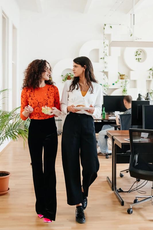 two women walking in an office modera second avenue apartments in denver co