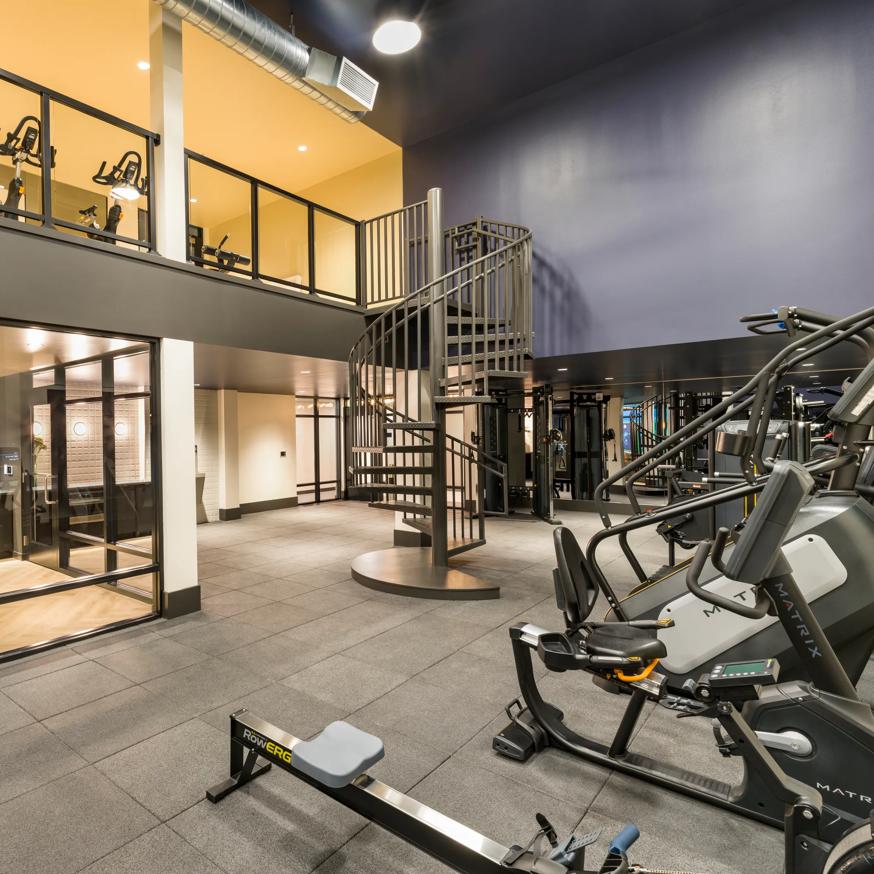rendering of fitness center with two stories and cardio equipment modera beaverton apartment homes for rent in or