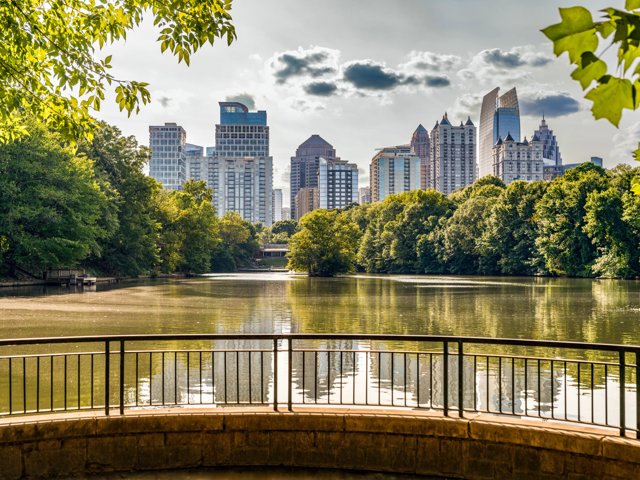 city view from large park with body of water modera parkside apartment homes for rent in atl ga