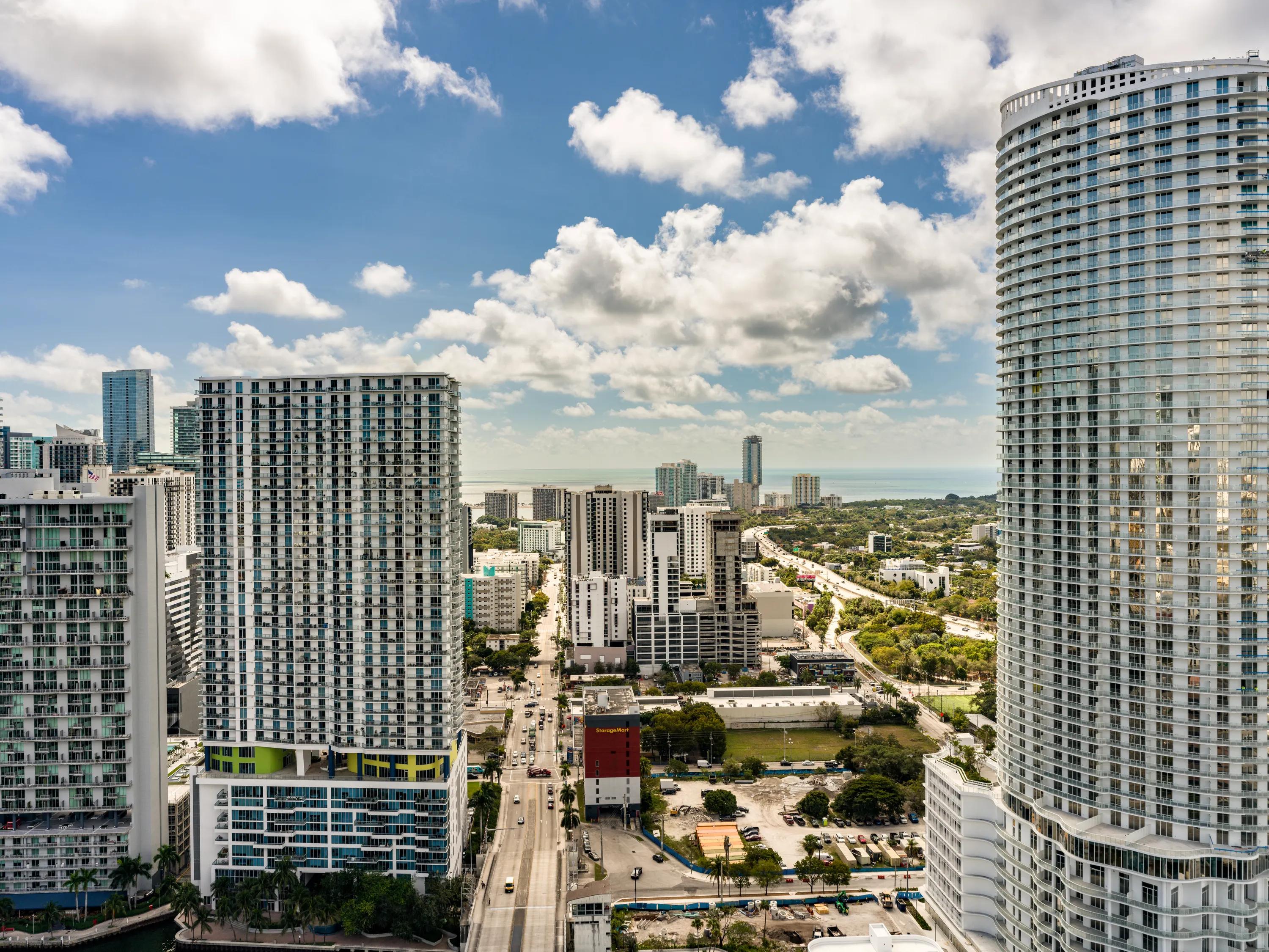 building tower adjacent to neighboring buildings aerial view modera riverside apartment homes for rent in miami fl