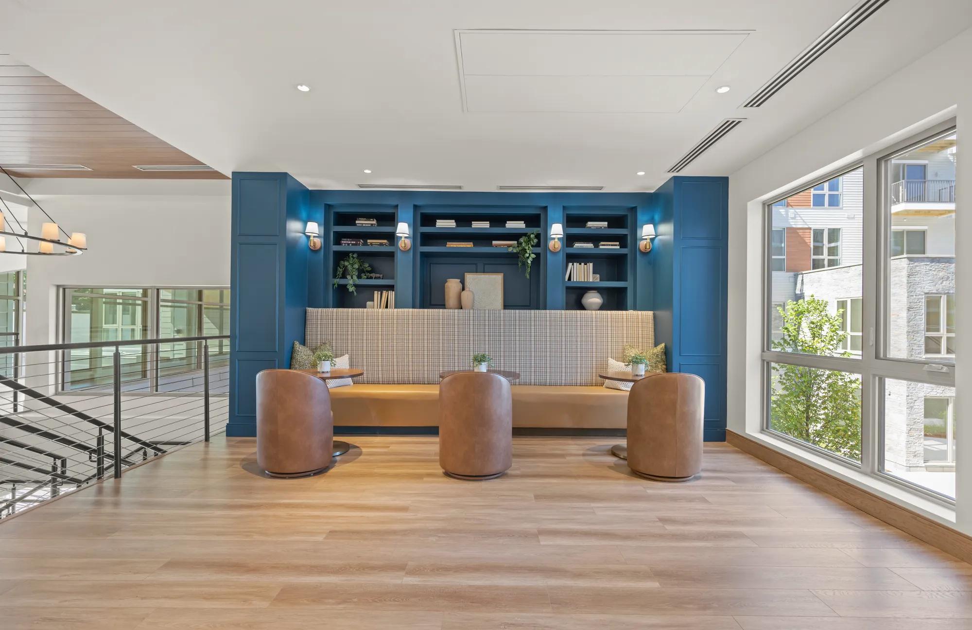 cafe style tables and work from home space with behind built-in cabinetry at modera newton apartment homes for rent in ma