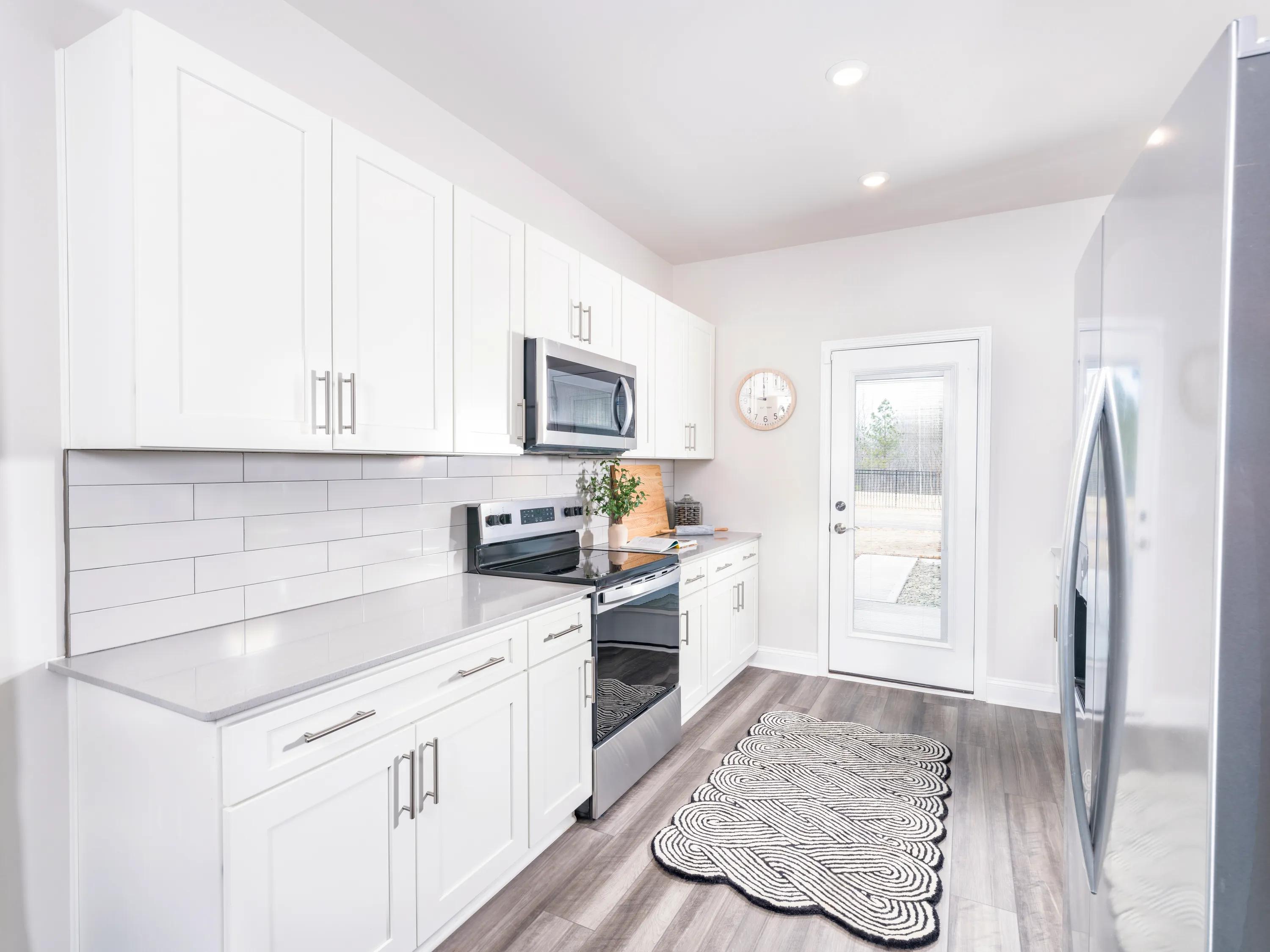 modern kitchen with stainless appliances amavi brier creek homes for rent in durham nc