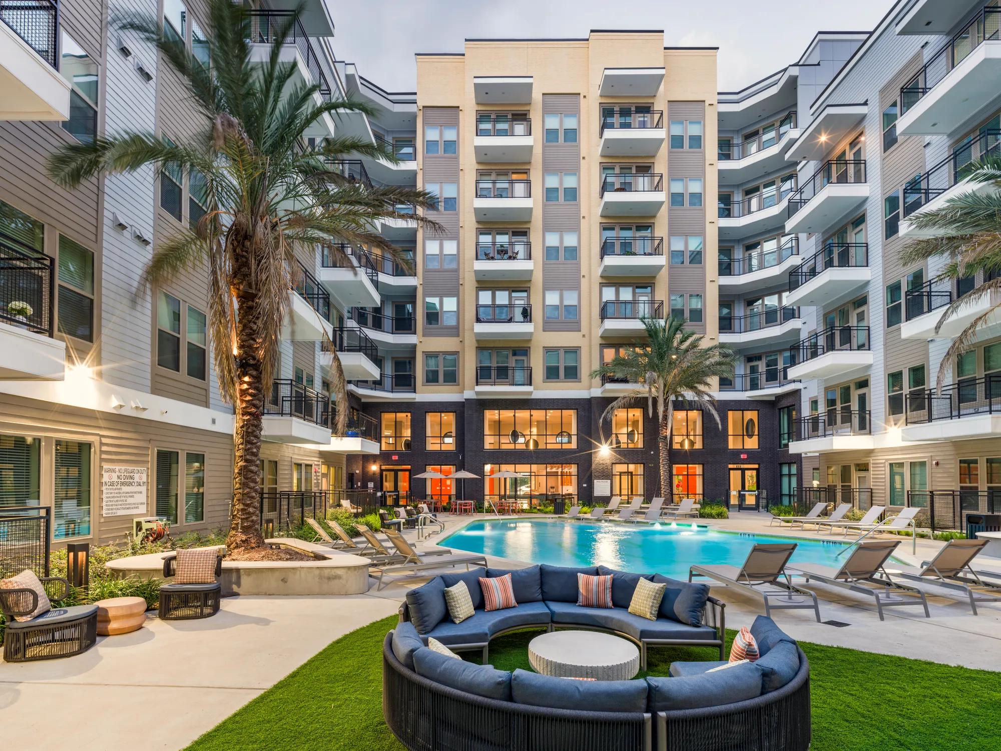 woman relaxing on edge of pool modera garden oaks apartment homes for rent in houton tx
