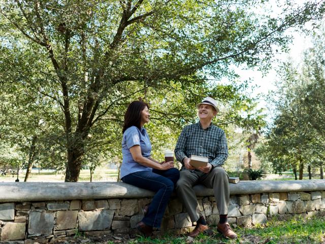 people sitting on wall in park talking modera sobro apartment homes for rent in nashville tn