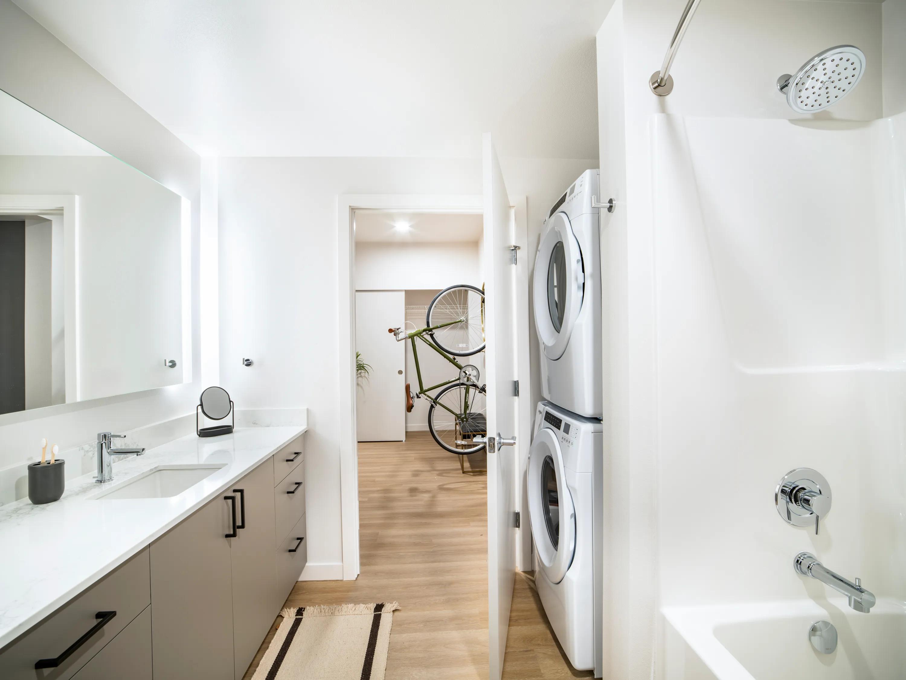 Designer bathrooms with quartz countertops and backlit mirrors