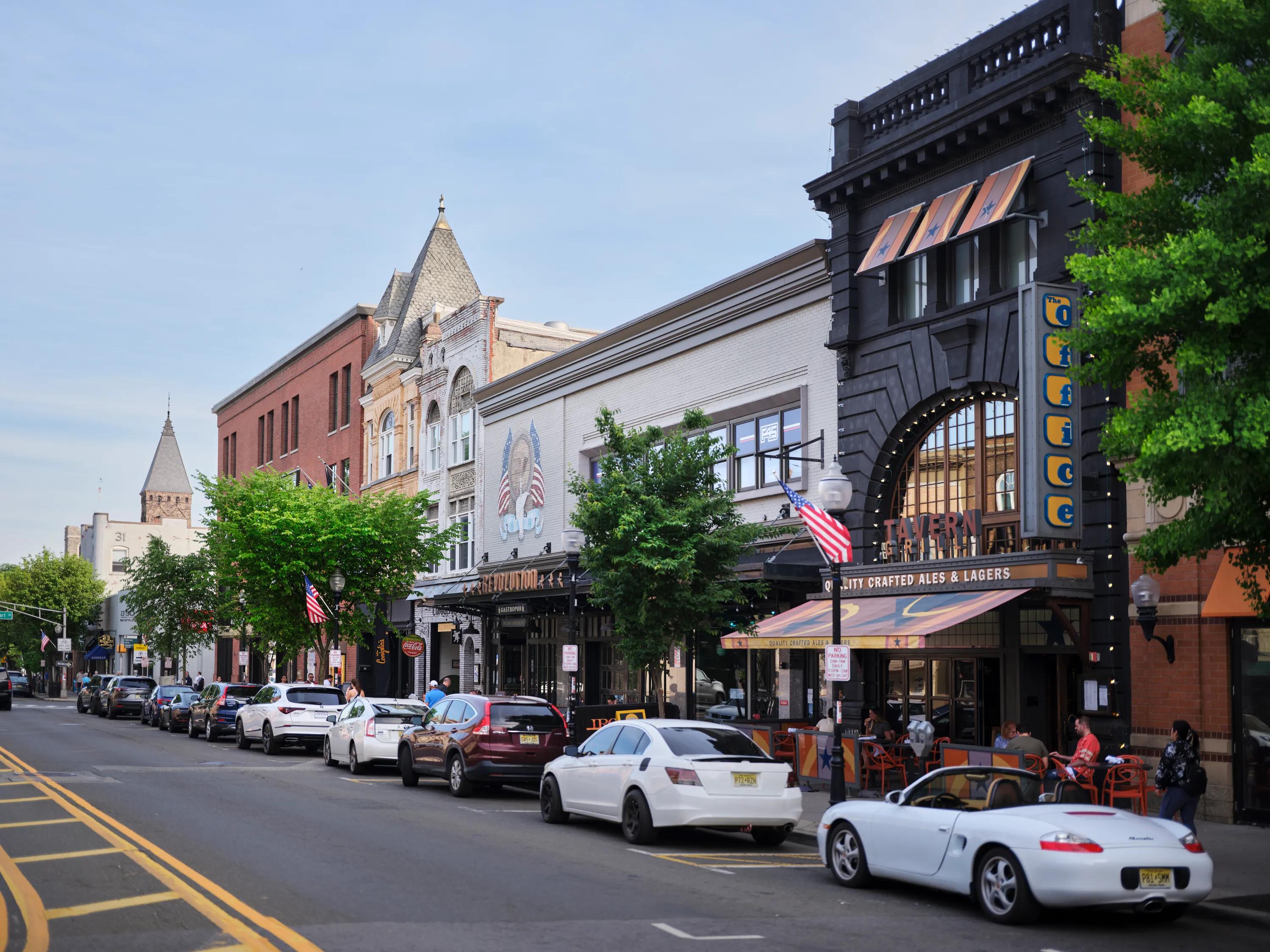 neighborhood with shops lining street on blue sky day metropolitan at 40 park apartment homes for rent in morristown nj