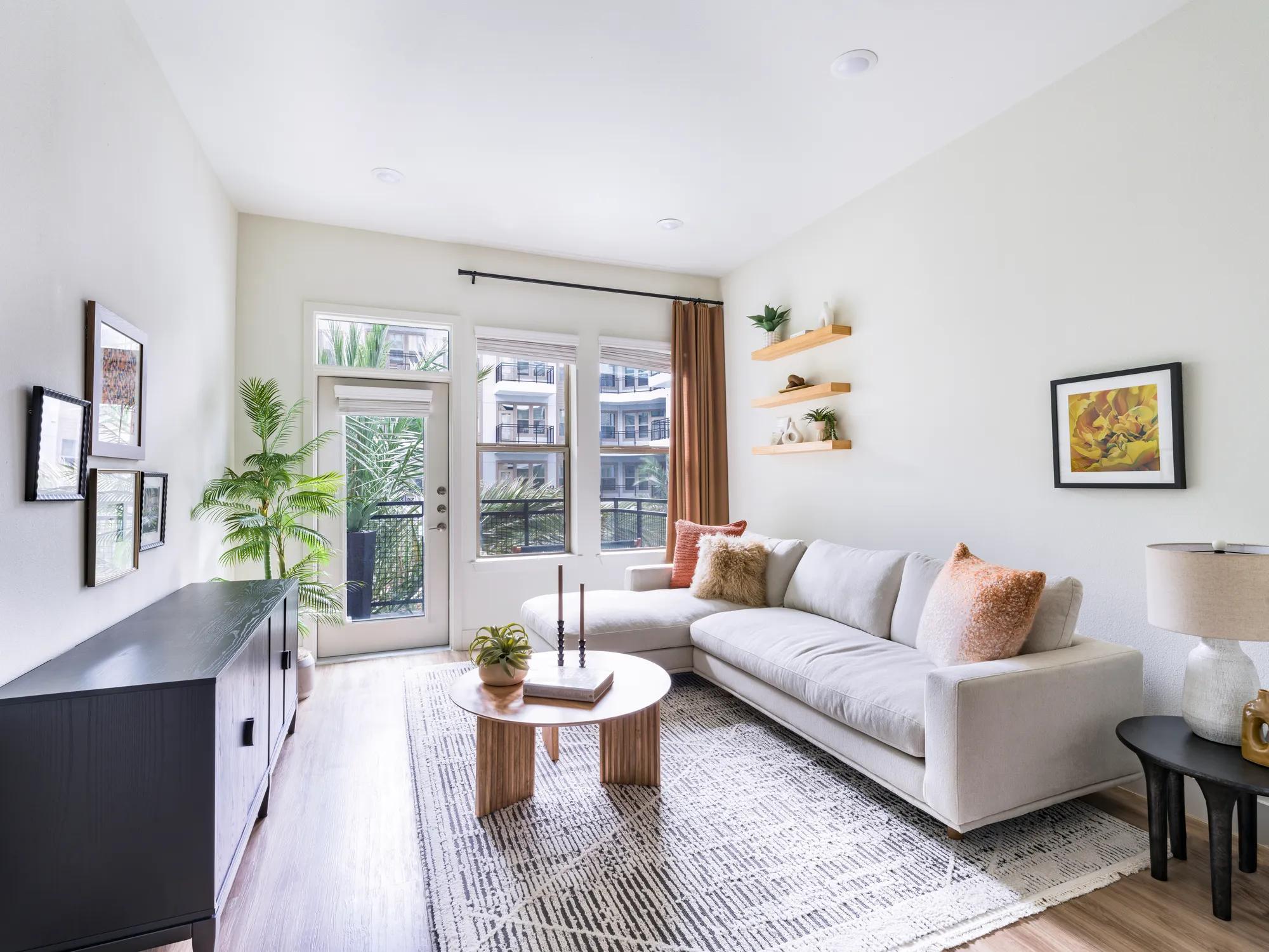 large living room area with private patio doors and oversized windows for plenty of natural light