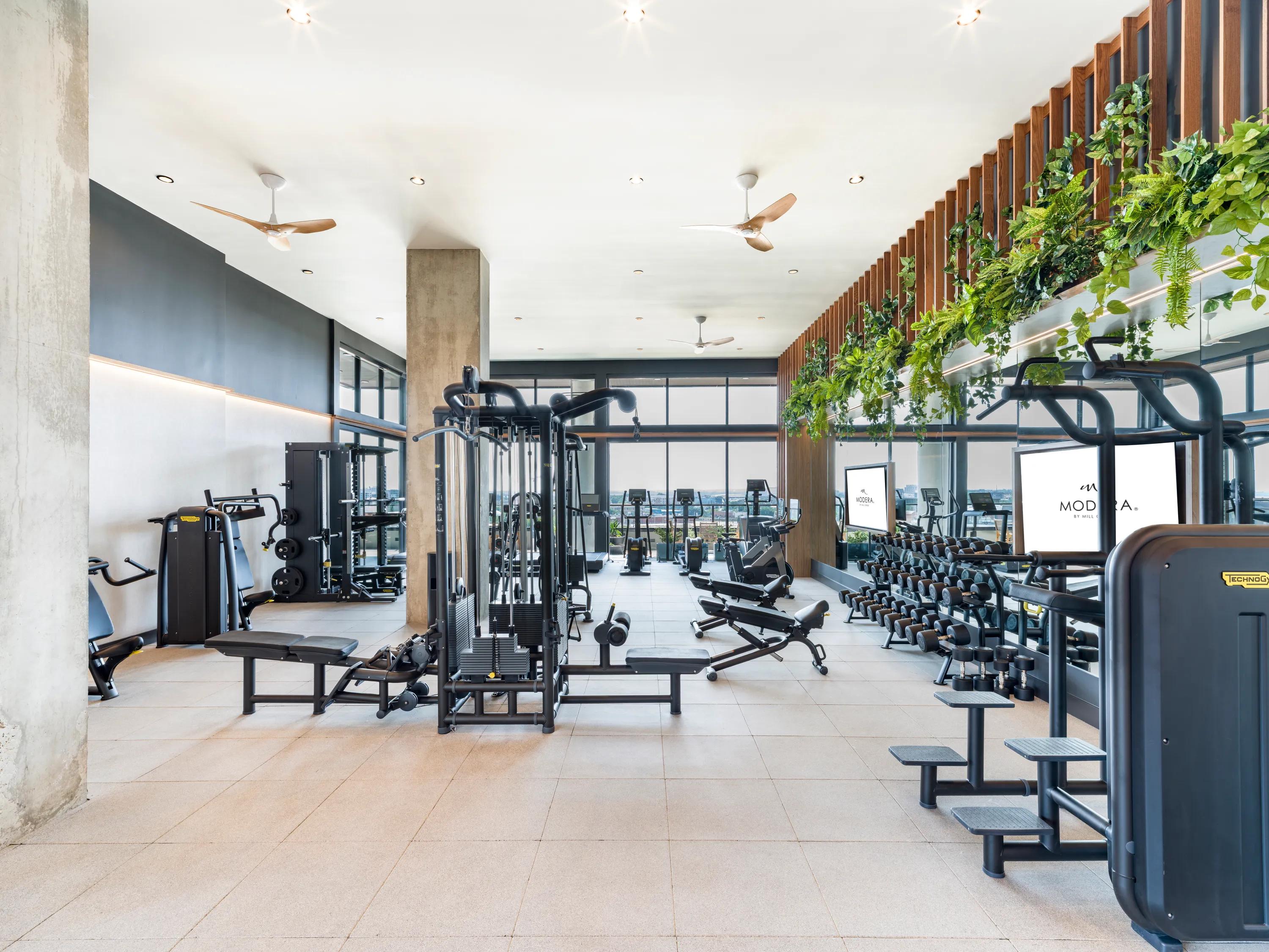 fitness studio with cardio equipment along wall rendering modera st. paul apartment homes for rent in dallas tx