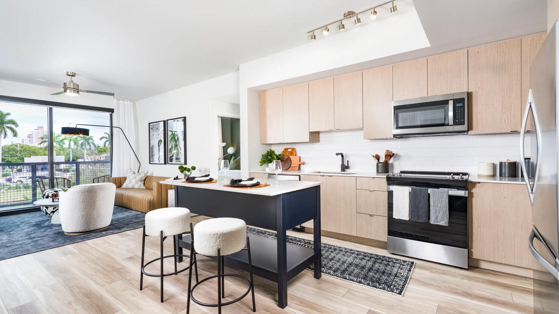 modera aventura apartments in miami kitchen with stainless steel appliances and wood style cabinetry