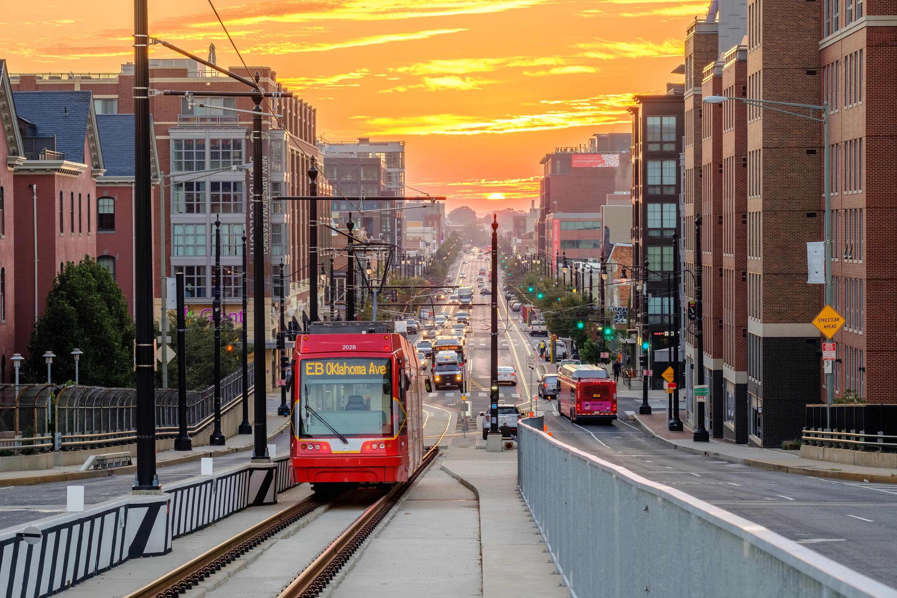 street car moving alongside road in city modera h street apartment homes for rent