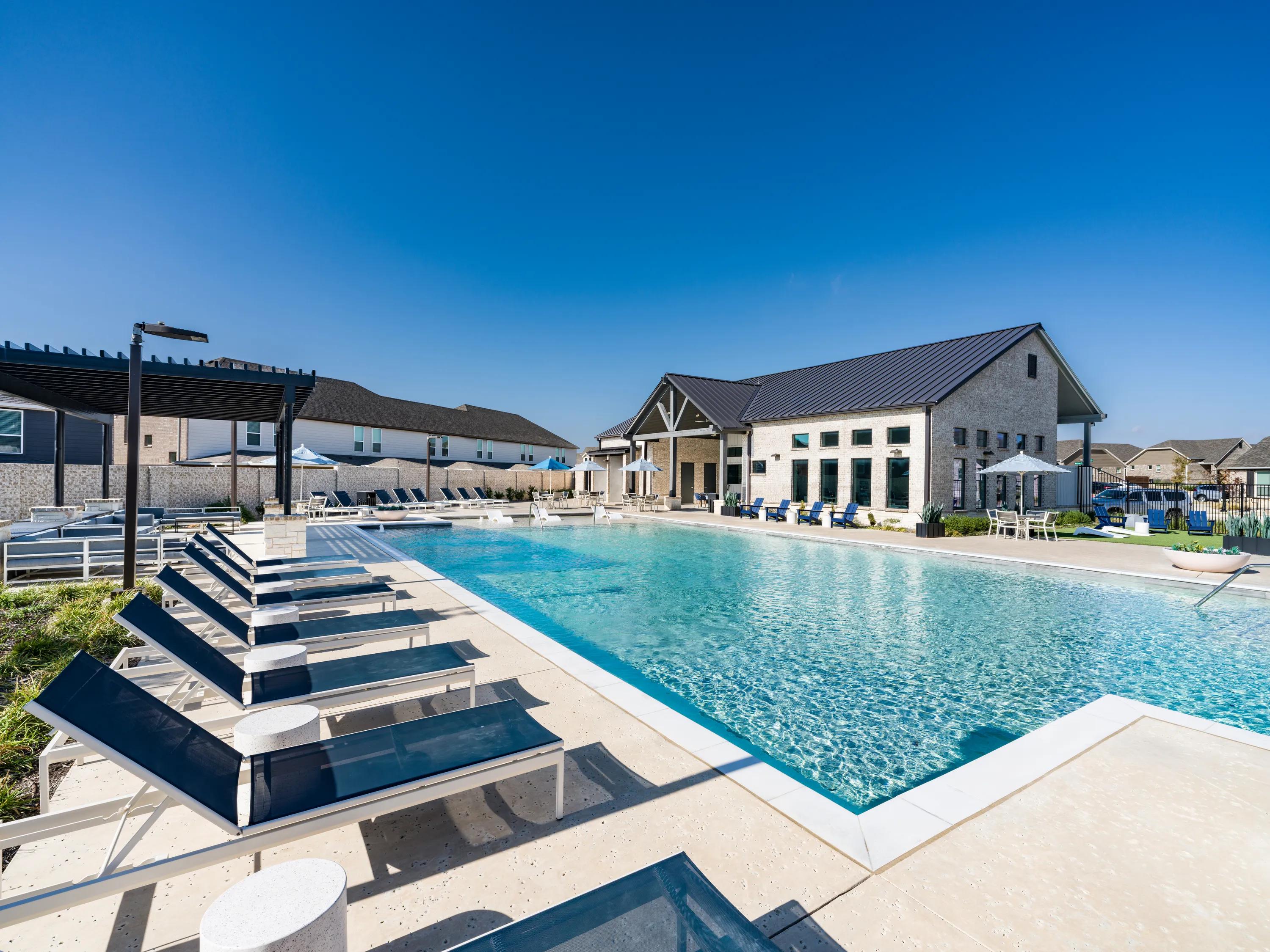 pool during the day with sundeck amavi celina single family homes for rent in texas