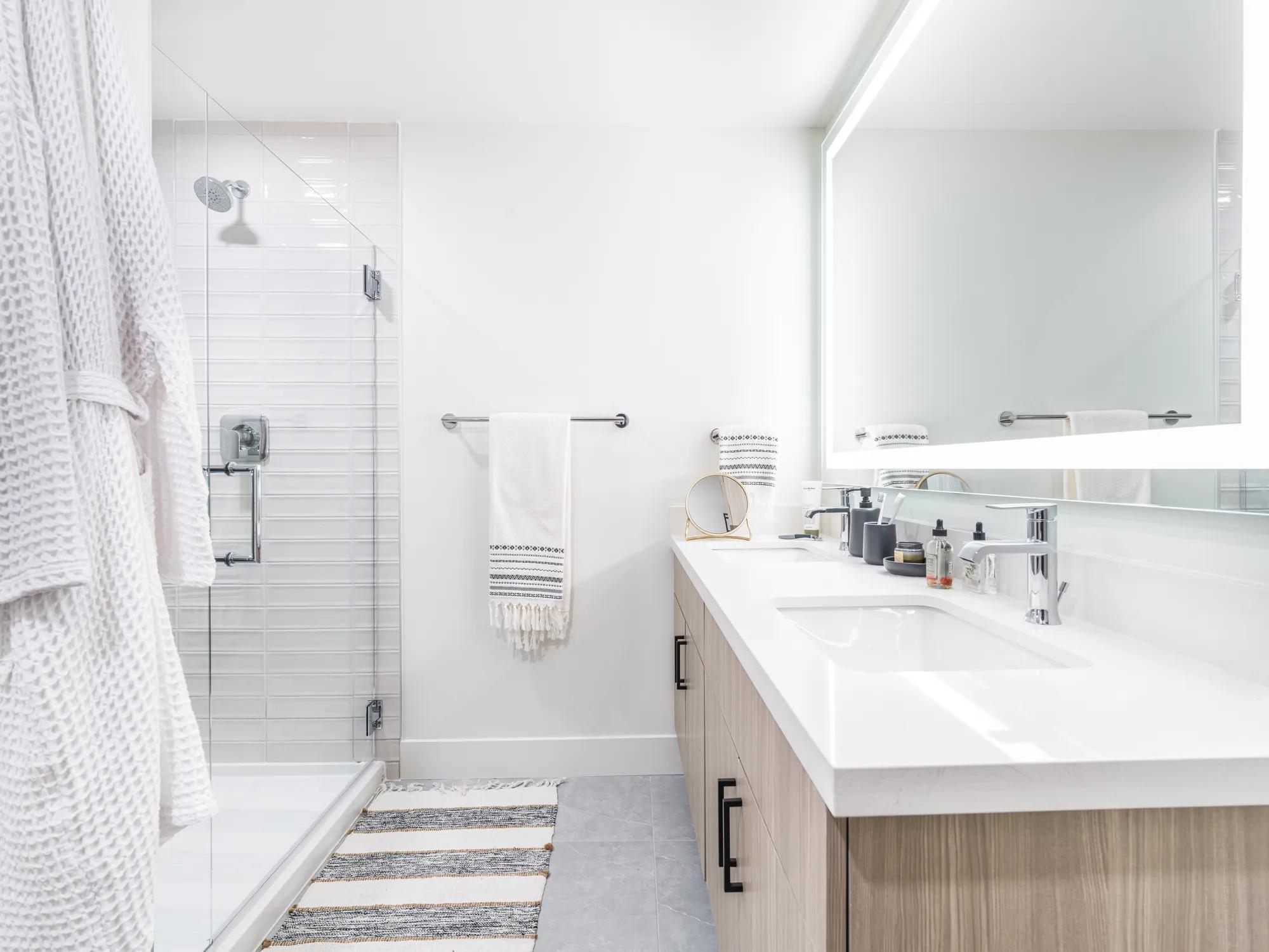 designer bathroom finishes with quartz countertops and wooden surrounds