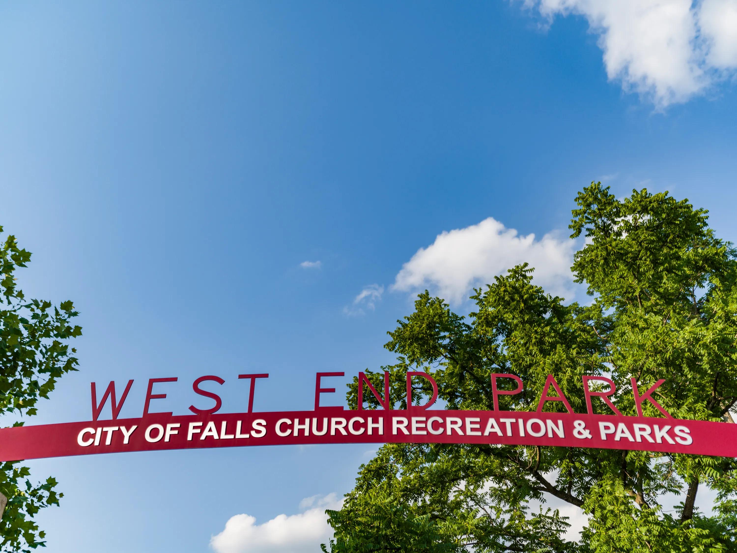 west end park in falls church sign with trees behind at modera falls church apartment homes for rent in va