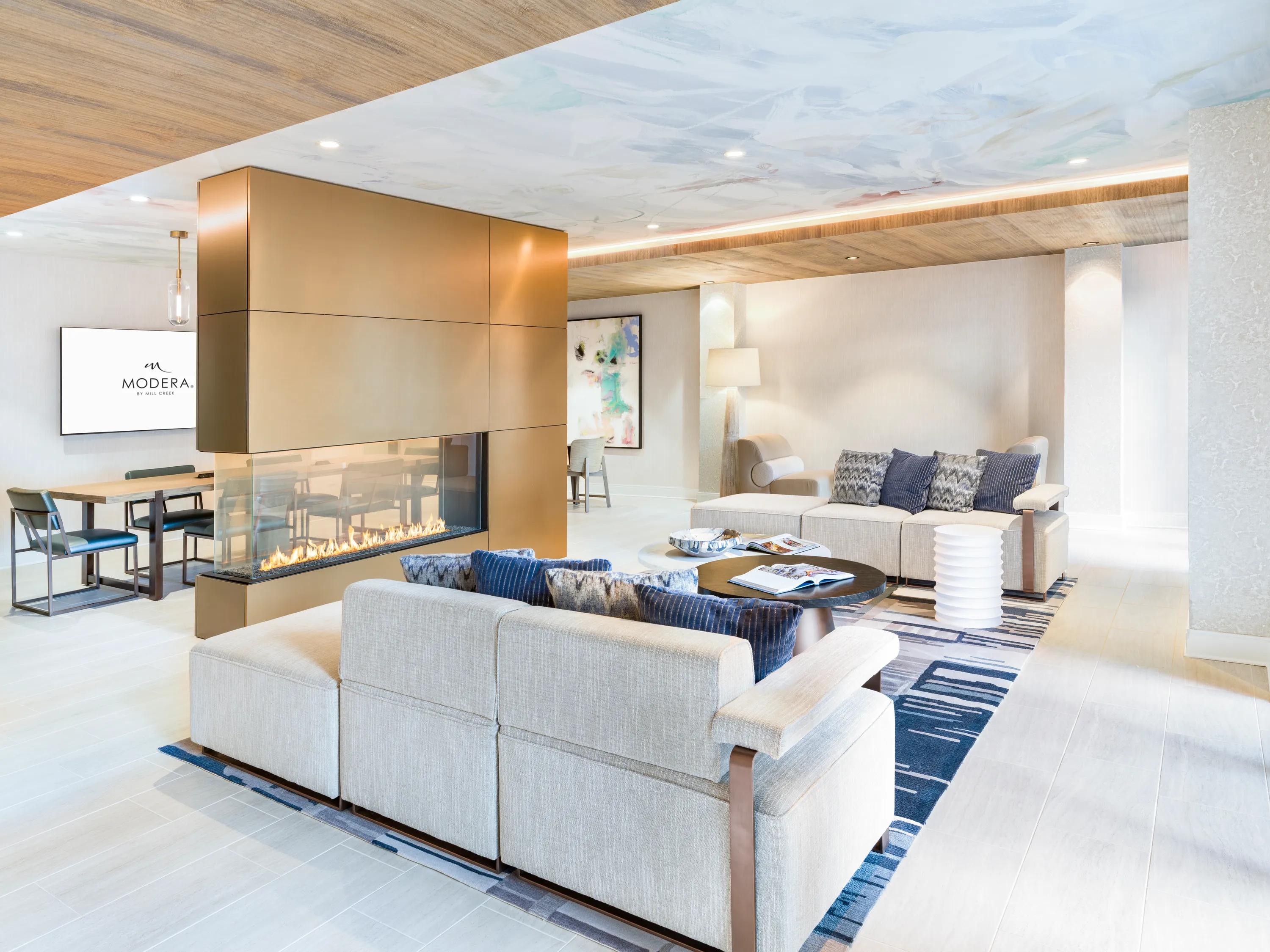indoor lounge with cozy seating and fireplace modera liberty row charlotte nc apartments