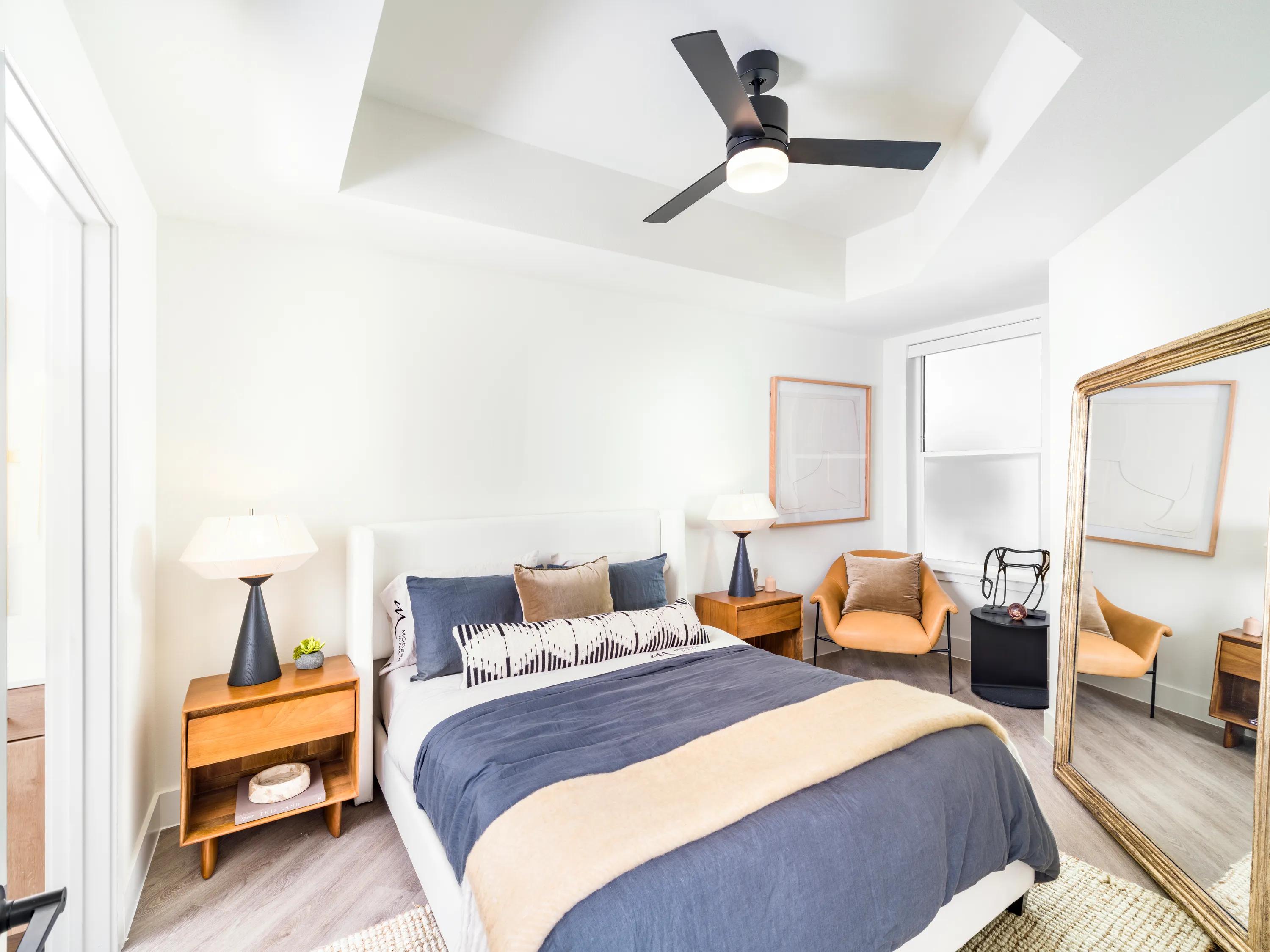 large bedrooms with ceiling fans and hardwood style flooring modera st paul dallas tx